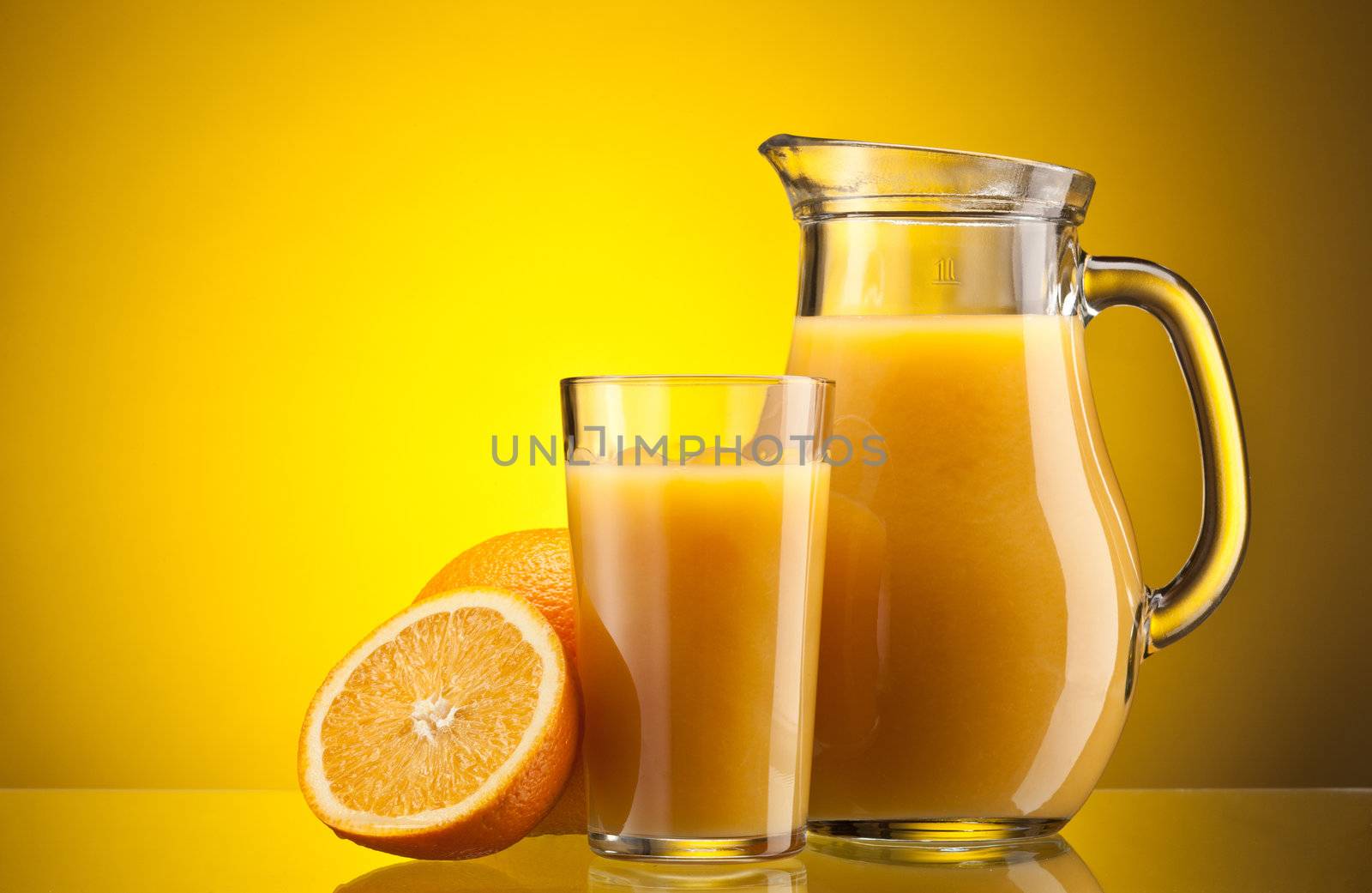 Orange juice over yellow with ripe sliced orange