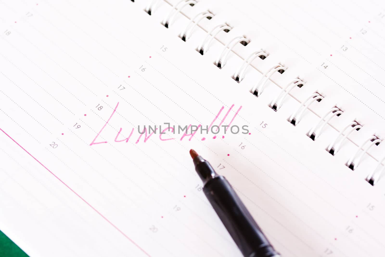 Diary with a reminder of the lunch and red marker