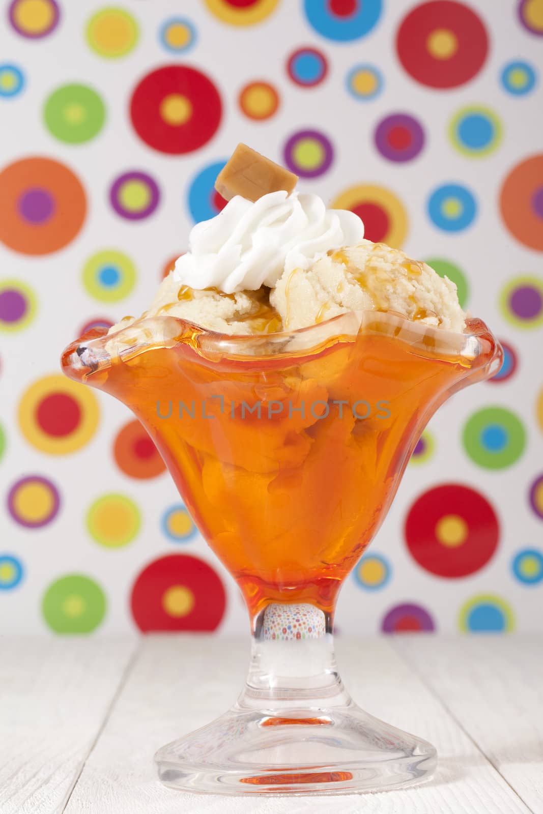 Image of glass of caramel ice cream with abstract background