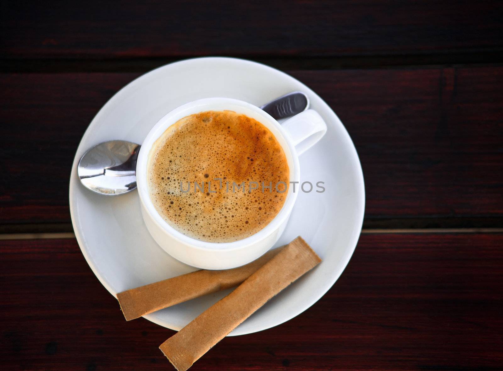 White porcelain cup of freshly brewed coffee with sugar