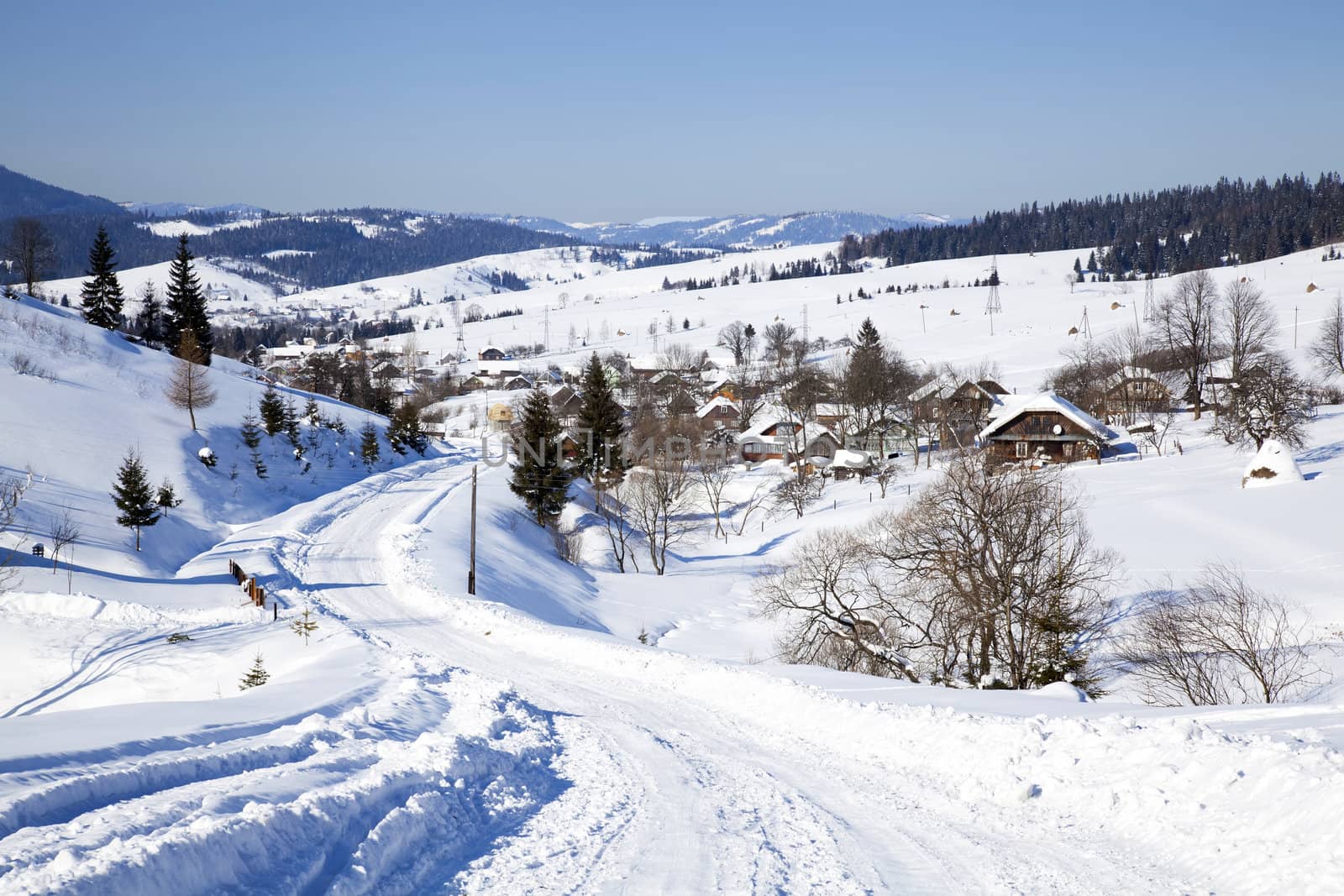 Winter road in the village in Carpathian mountains