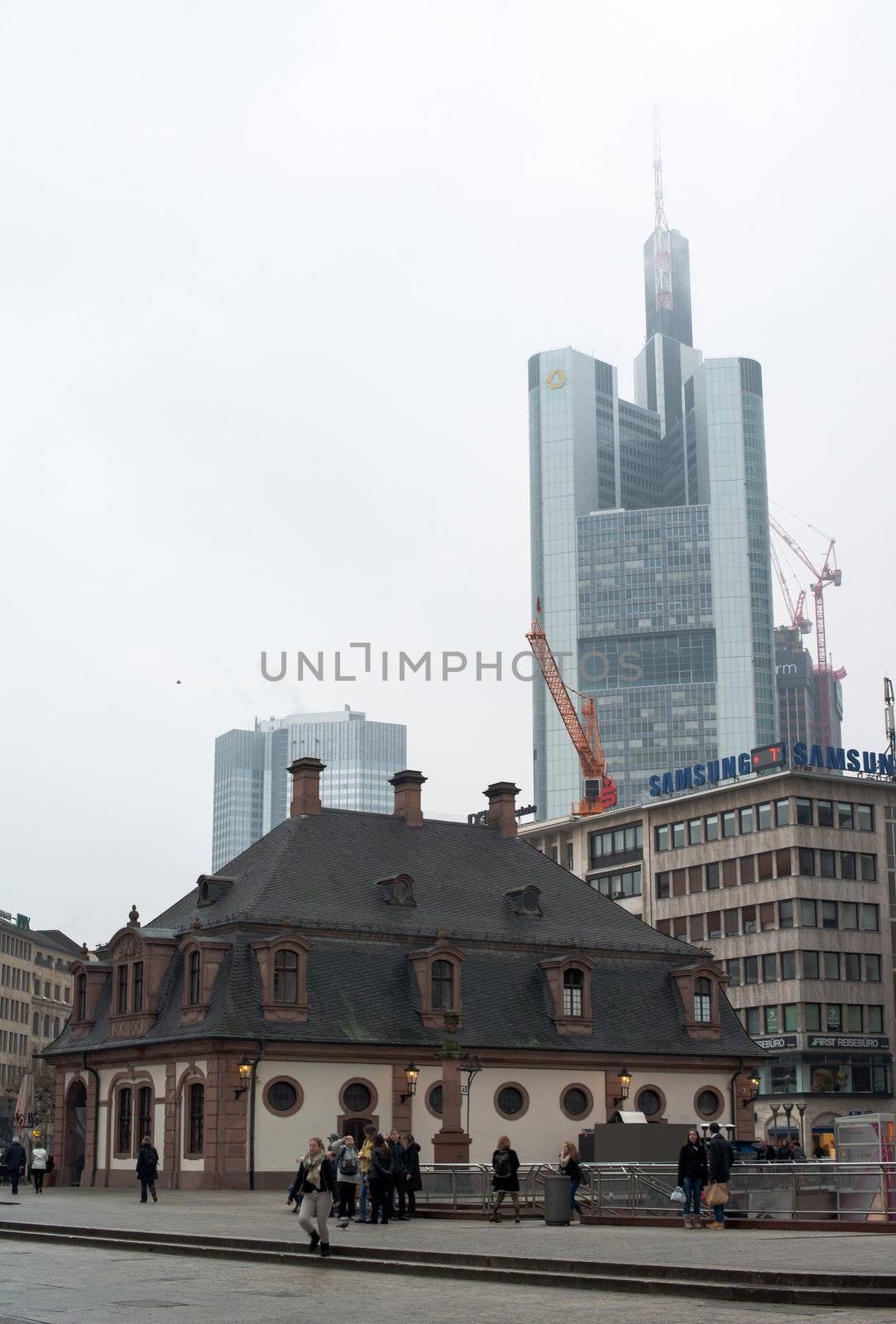 FRANKFURT, GERMANY – FEBRUARY 16, 2013: Hauptwache (guard-house) in downtown Frankfurt am Main, Germany on February 16, 2013. The landmark dates from 1730 and was reconstructed after World War 2. In the background the skyscraper building of Commerzbank is visible.