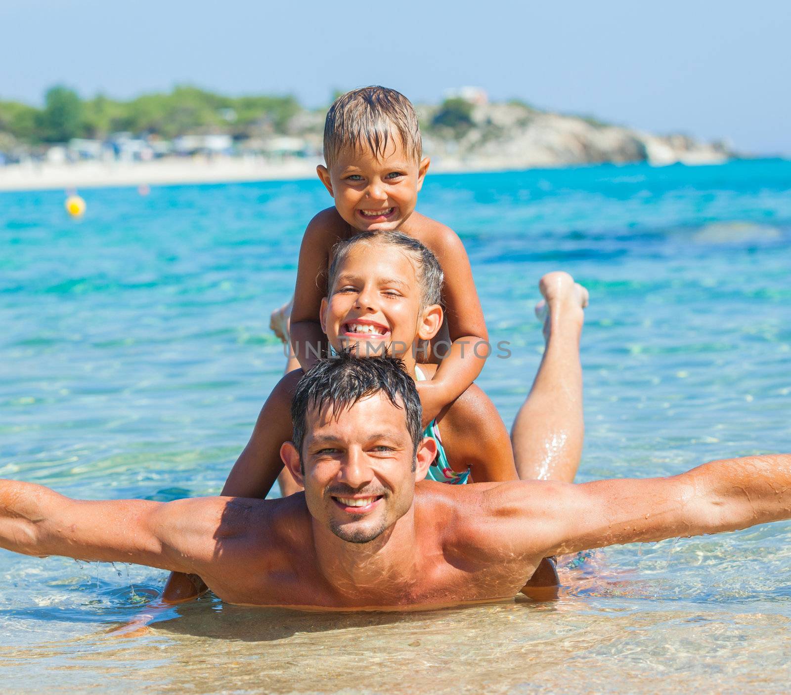 Father with his kids have fun and swim sea by maxoliki