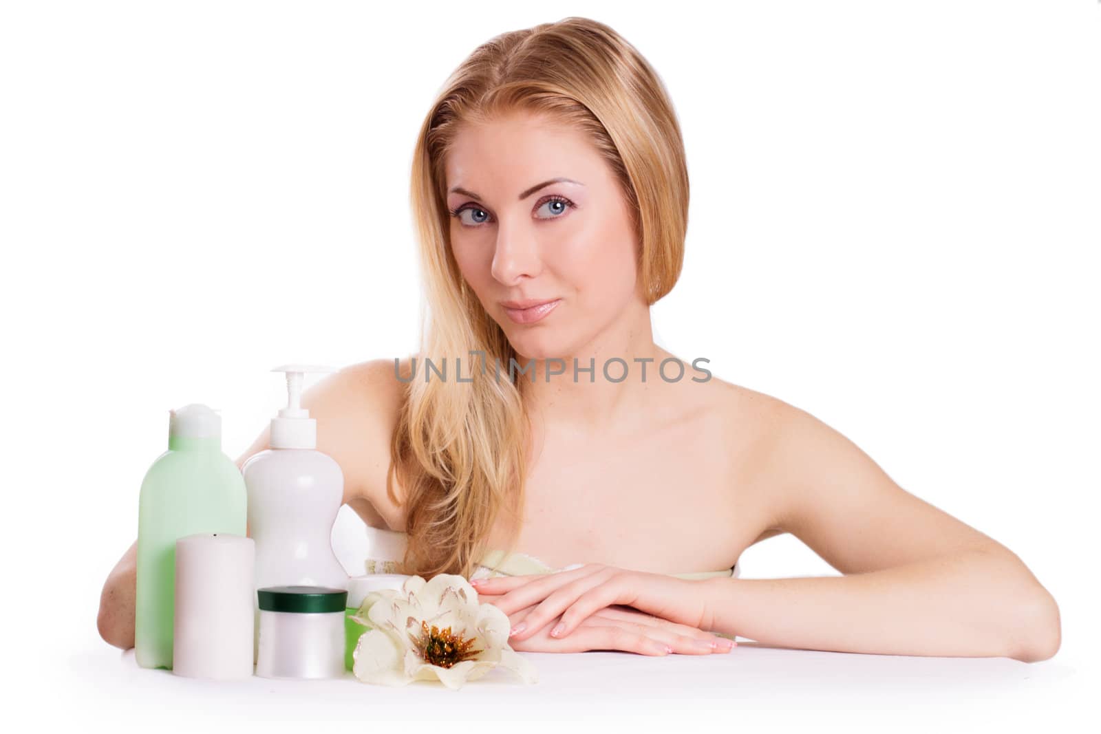 Sensual woman with skincare products isolated on white