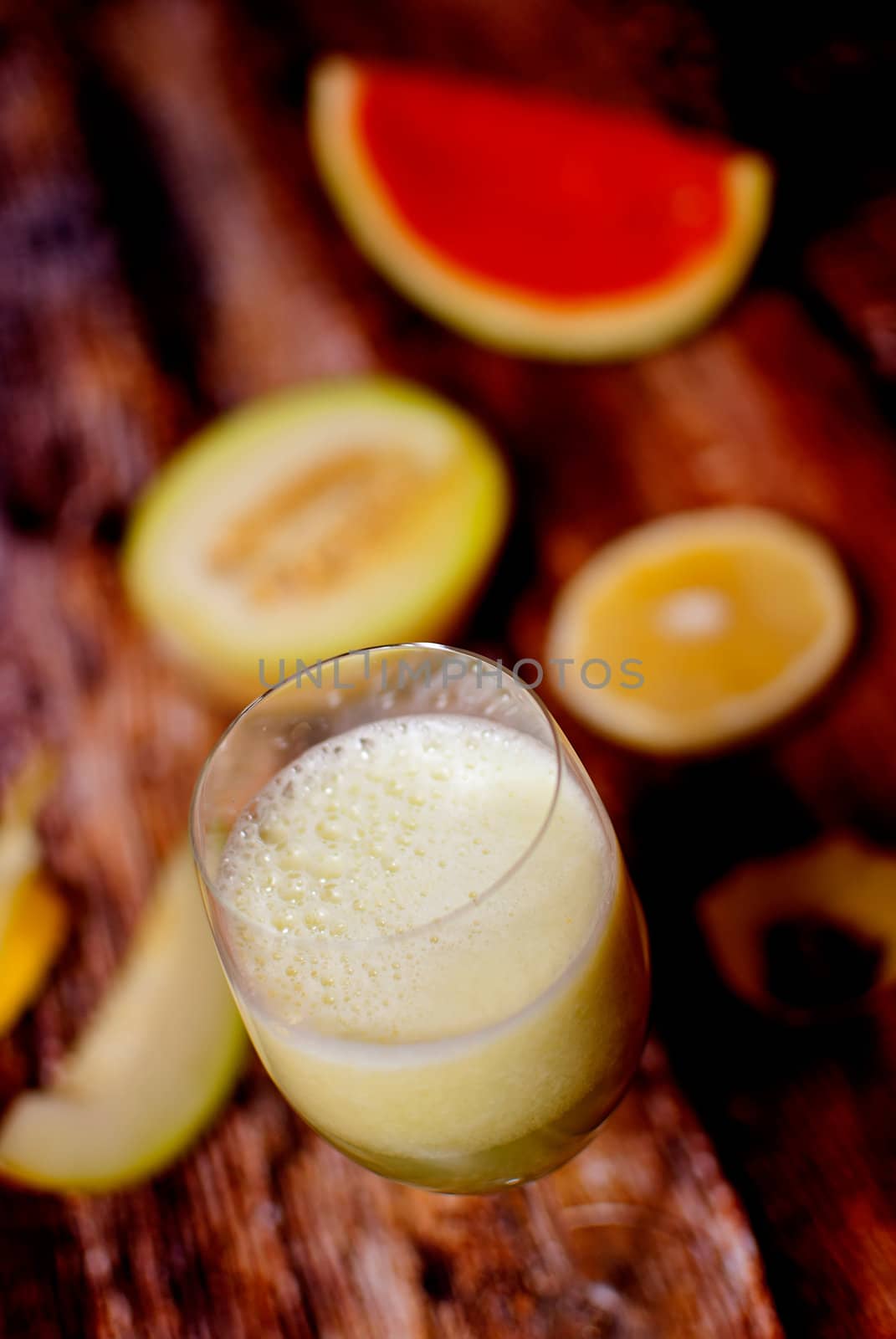 healthy juice made of freshly juiced fruits over wooden surface