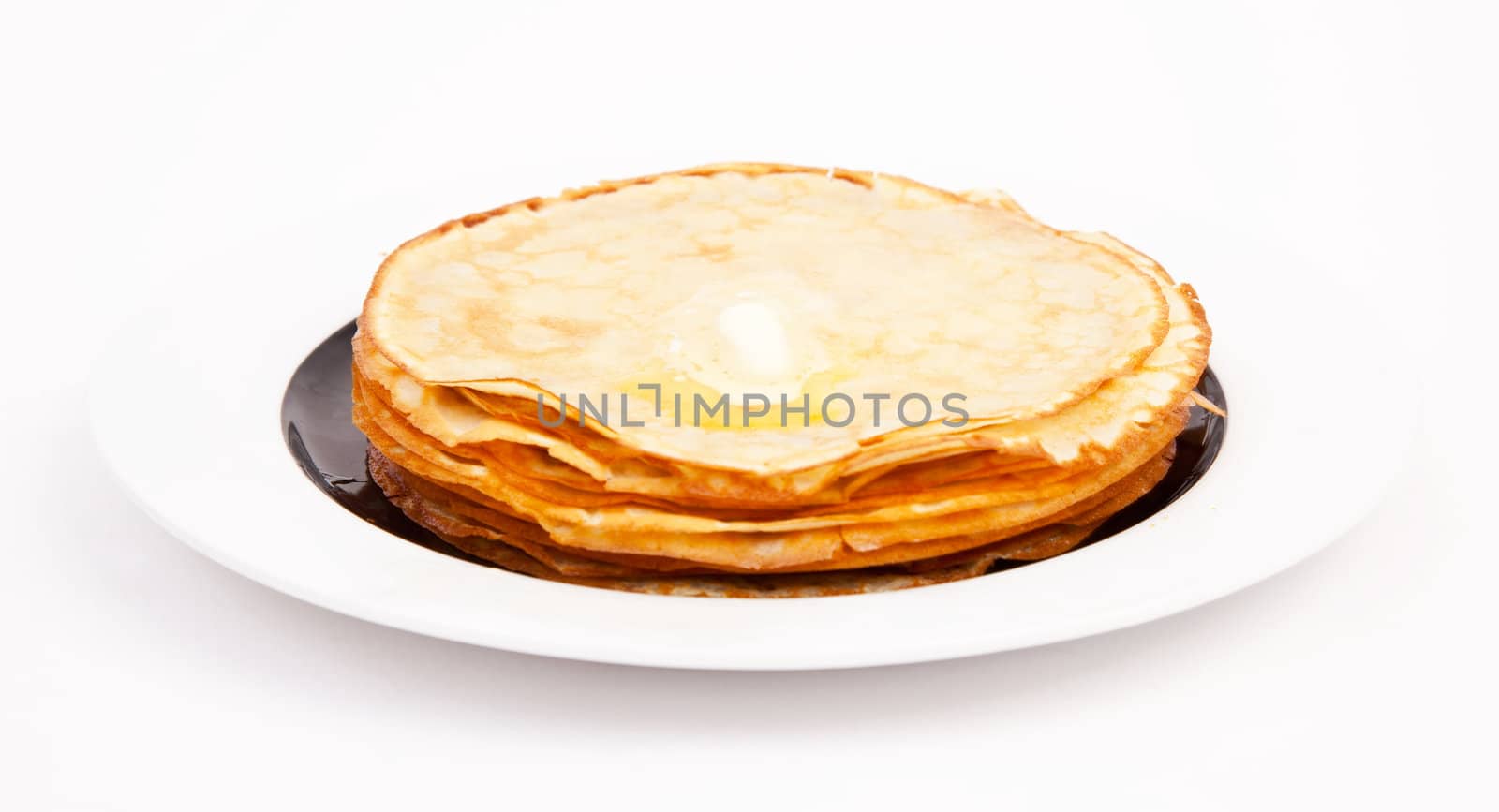 Crepes on white plate wit butter by RawGroup