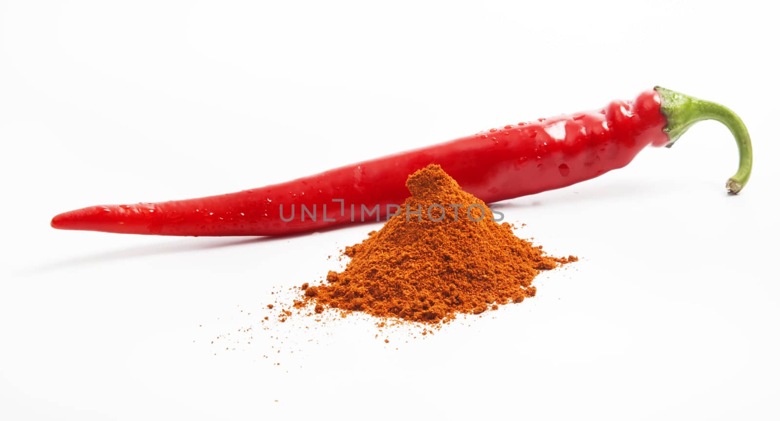 Long chili pepper with paprika isolated on white