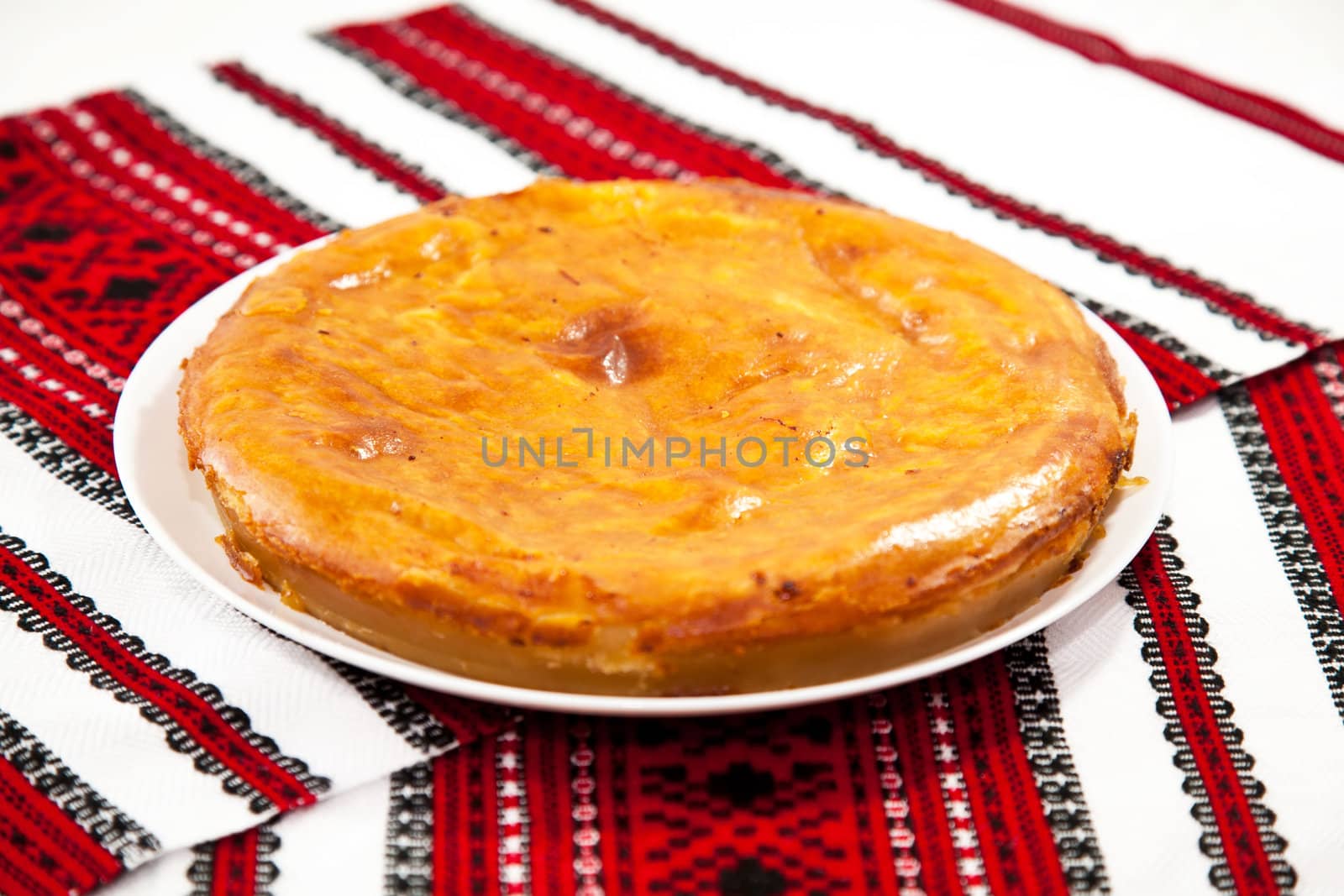 Onion and cheese pie on traditional ukrainian towel