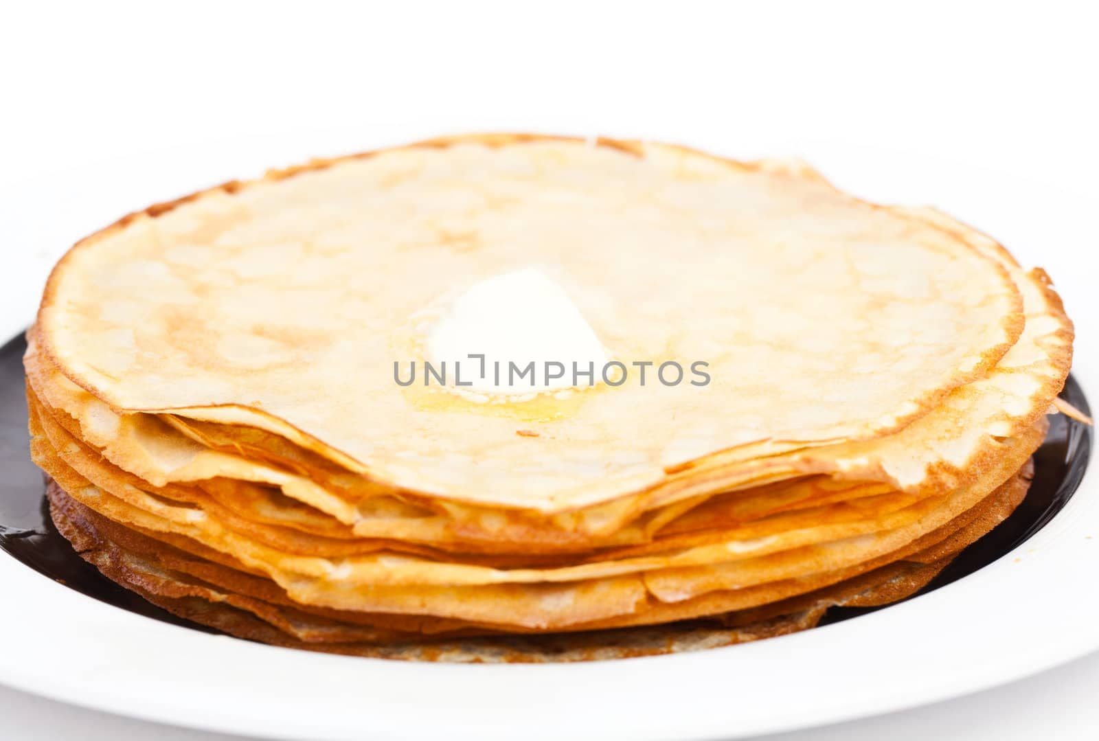 Crepes on white plate wit butter by RawGroup
