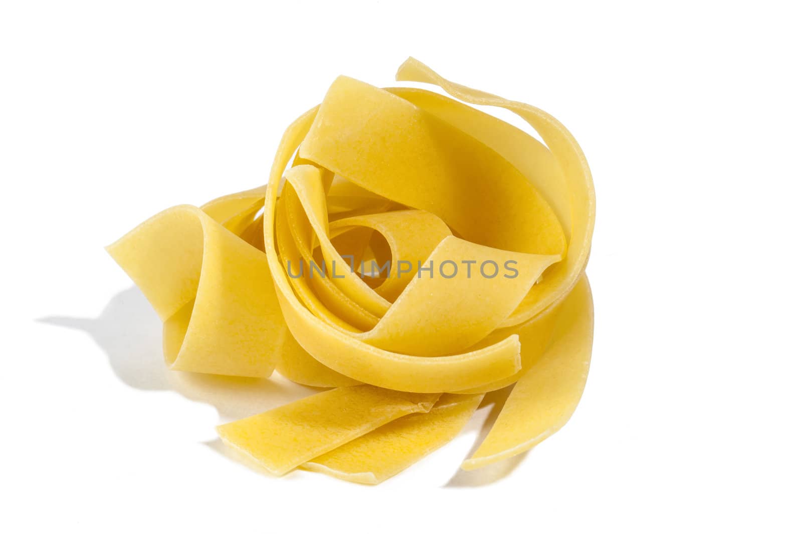 Raw pasta tagliatelle isolated on white background