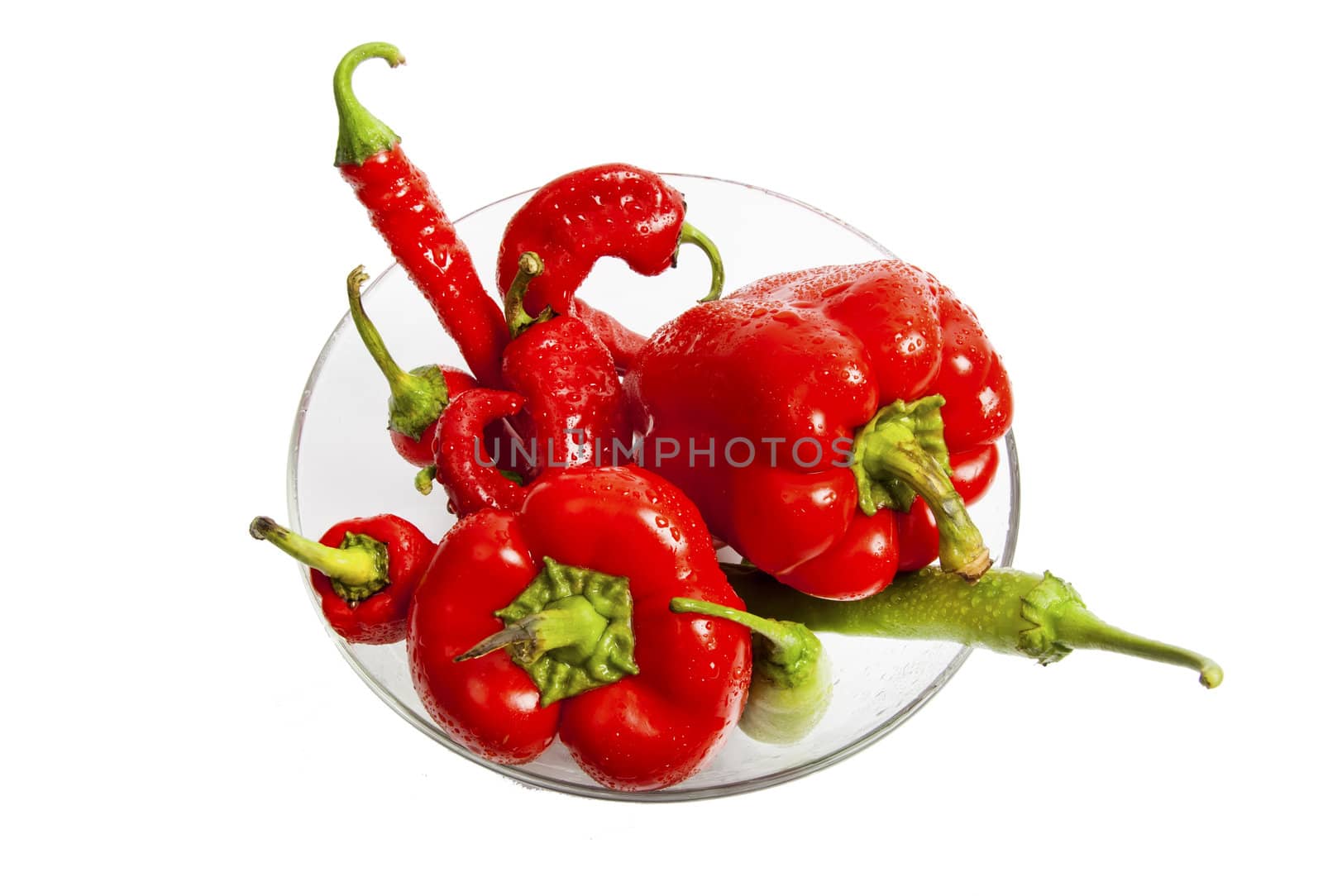 Red and green chili and bulgarian pepper in glass dish