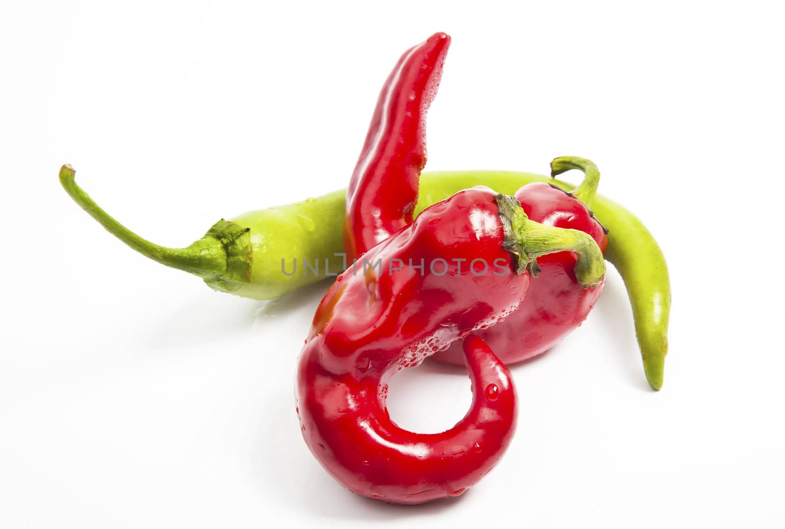 Red and green chili pepper isolated on white by RawGroup