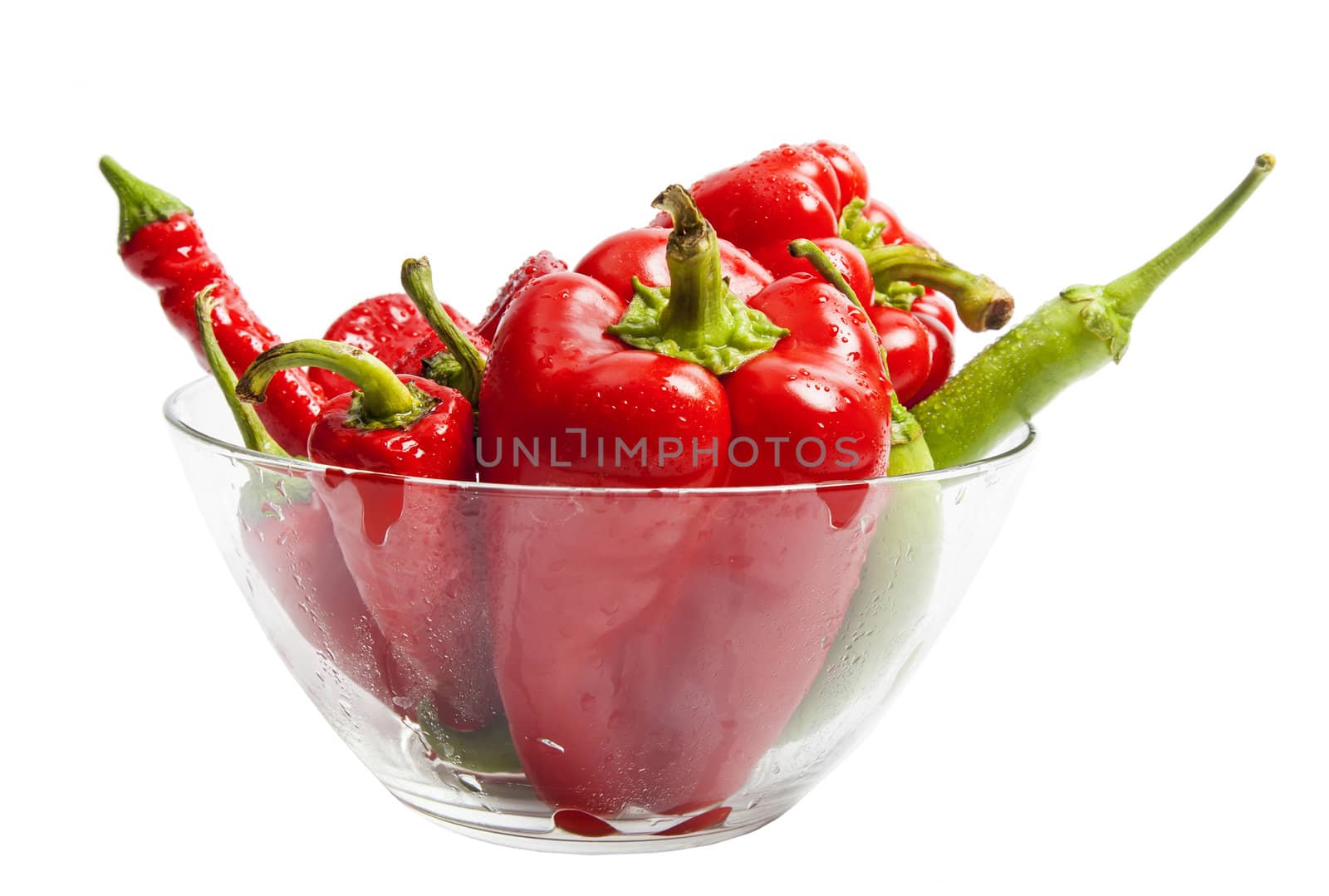 Red and green pepper in salad dish isolated on white