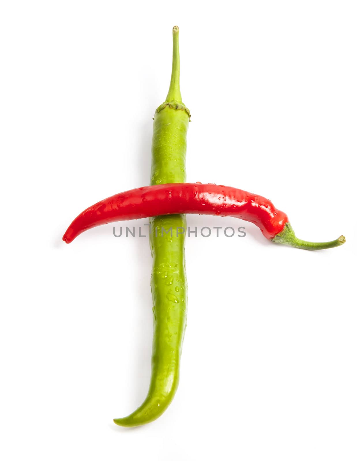 Red and green pepper in shape of cross isolated on white