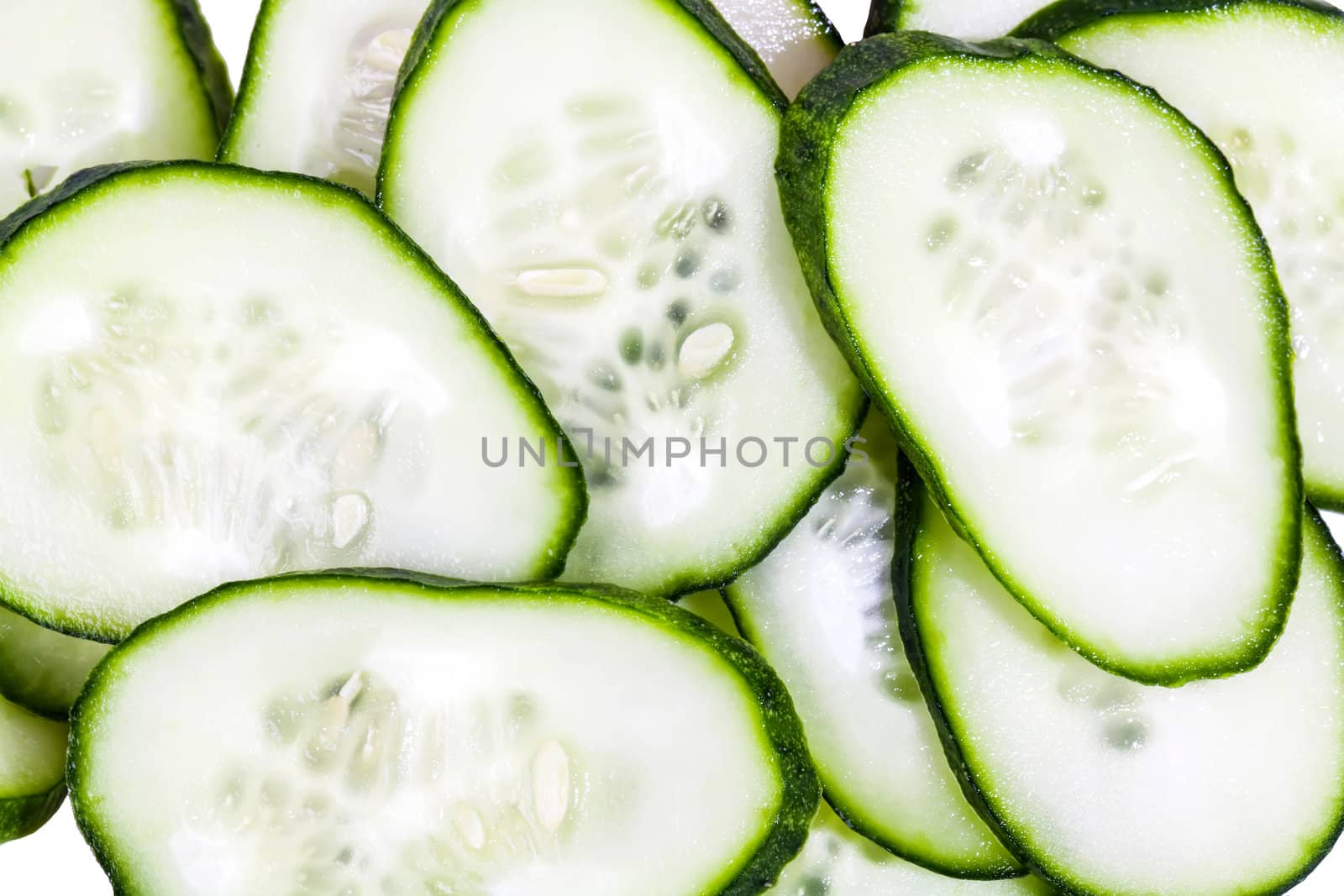 Slices of cucumbers background isolated on white