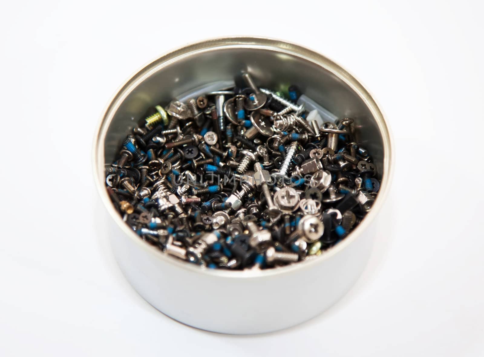 Jar of hobnails and screws on the white background