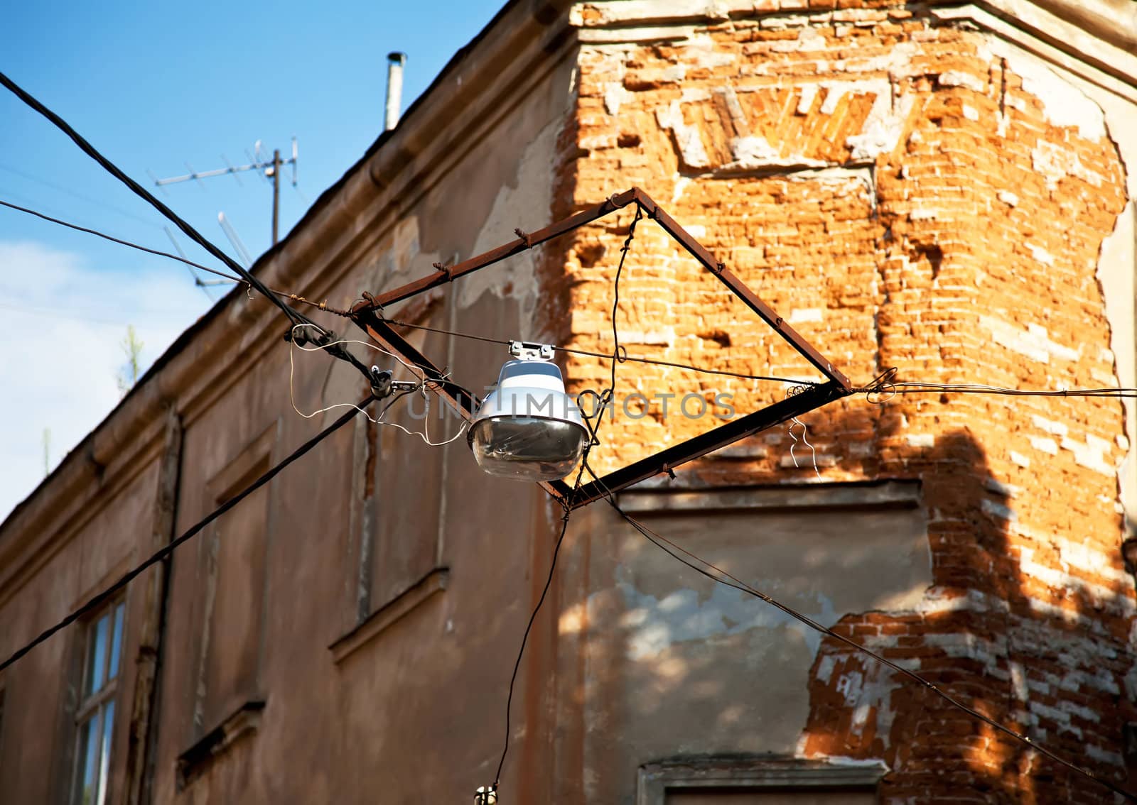 Old hanging city lantern and brick wall
