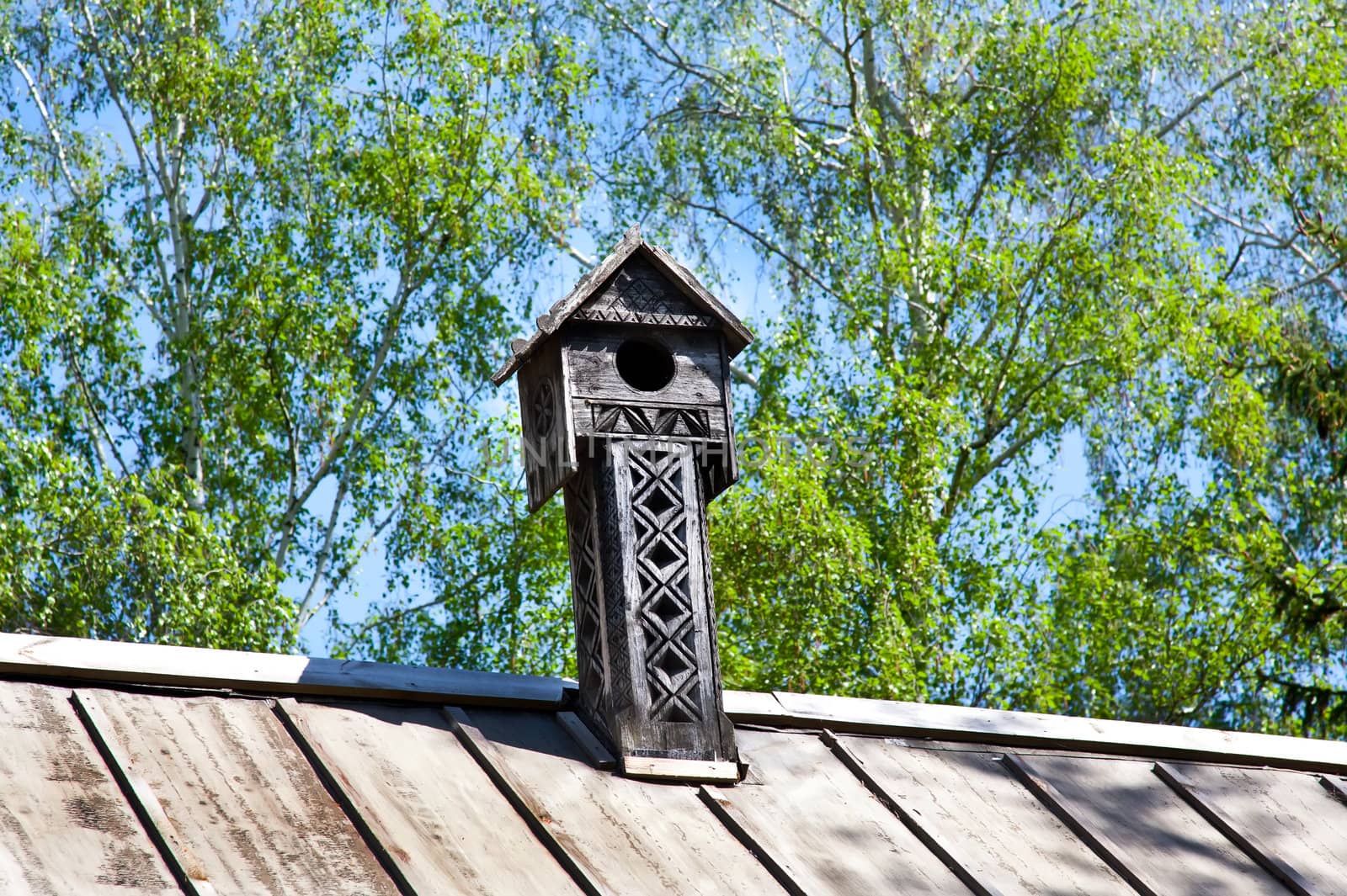 Wooden chimney with ornament on the roof
