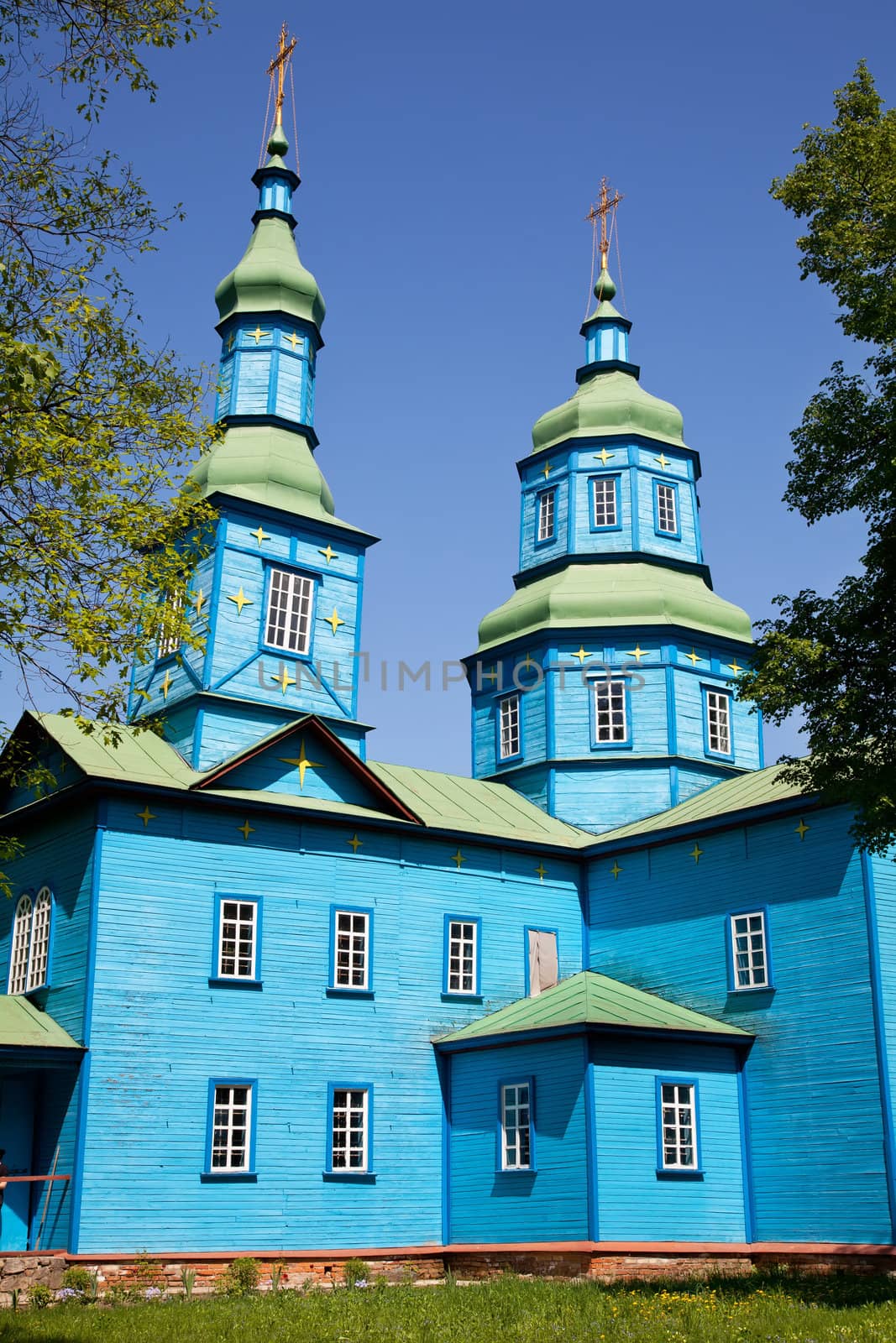 Blue wooden church in field