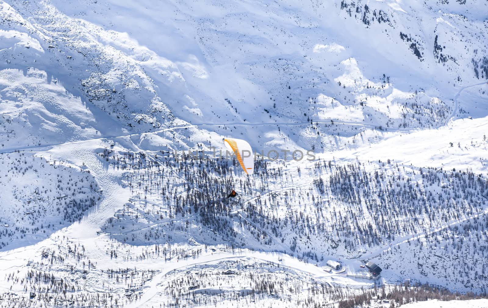 Alps snow hills with orange parachute