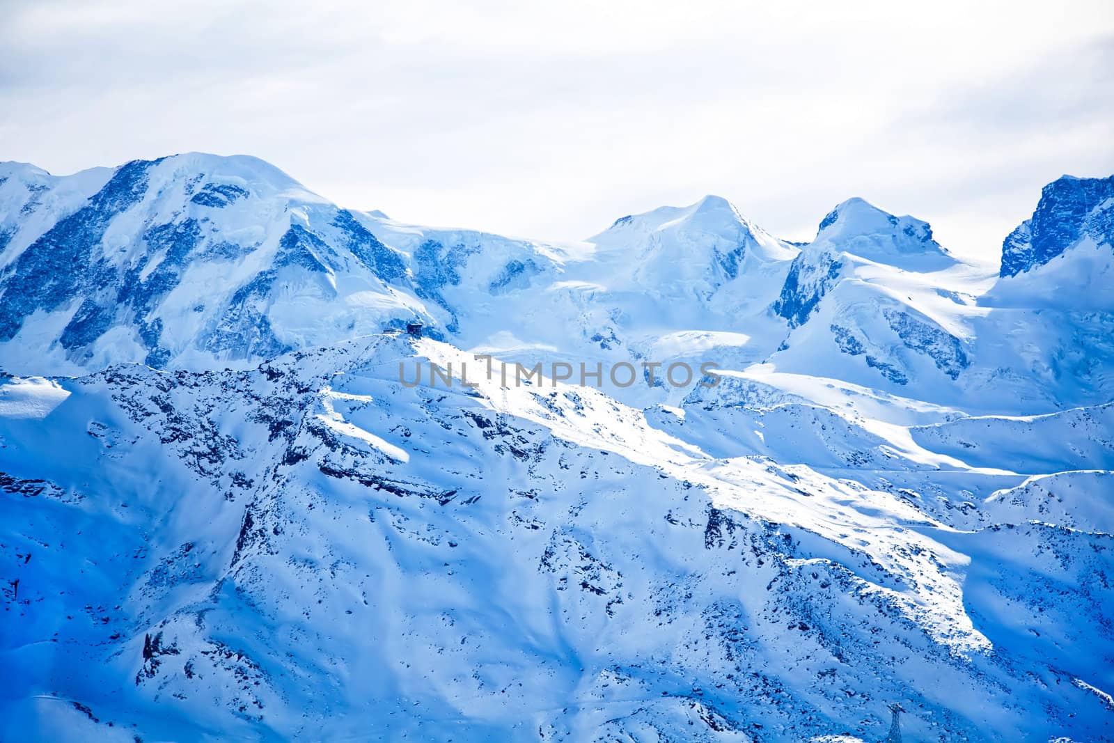 Swiss alps landscape with blue snow