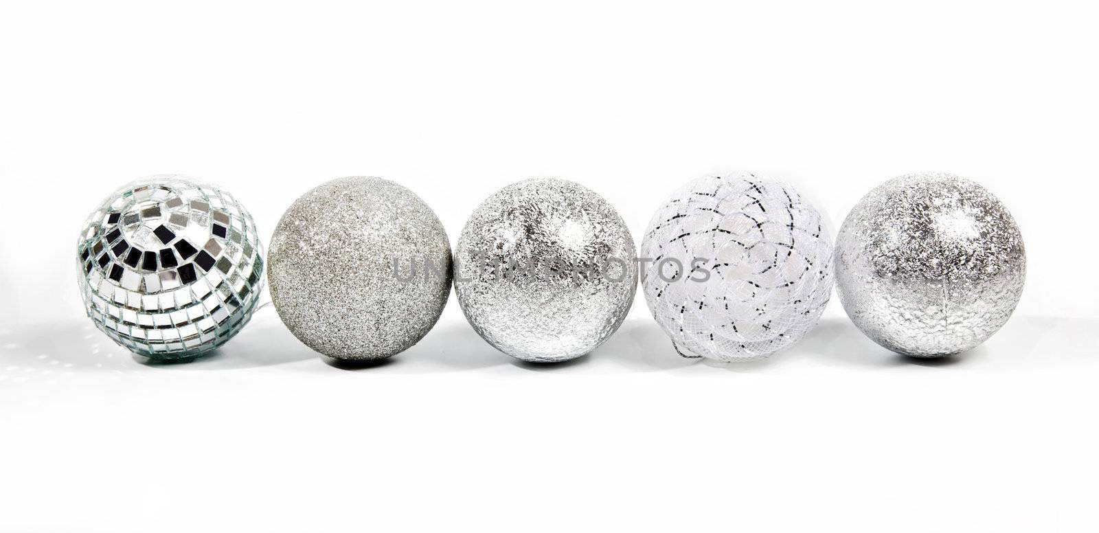 Five different silver new year balls by RawGroup