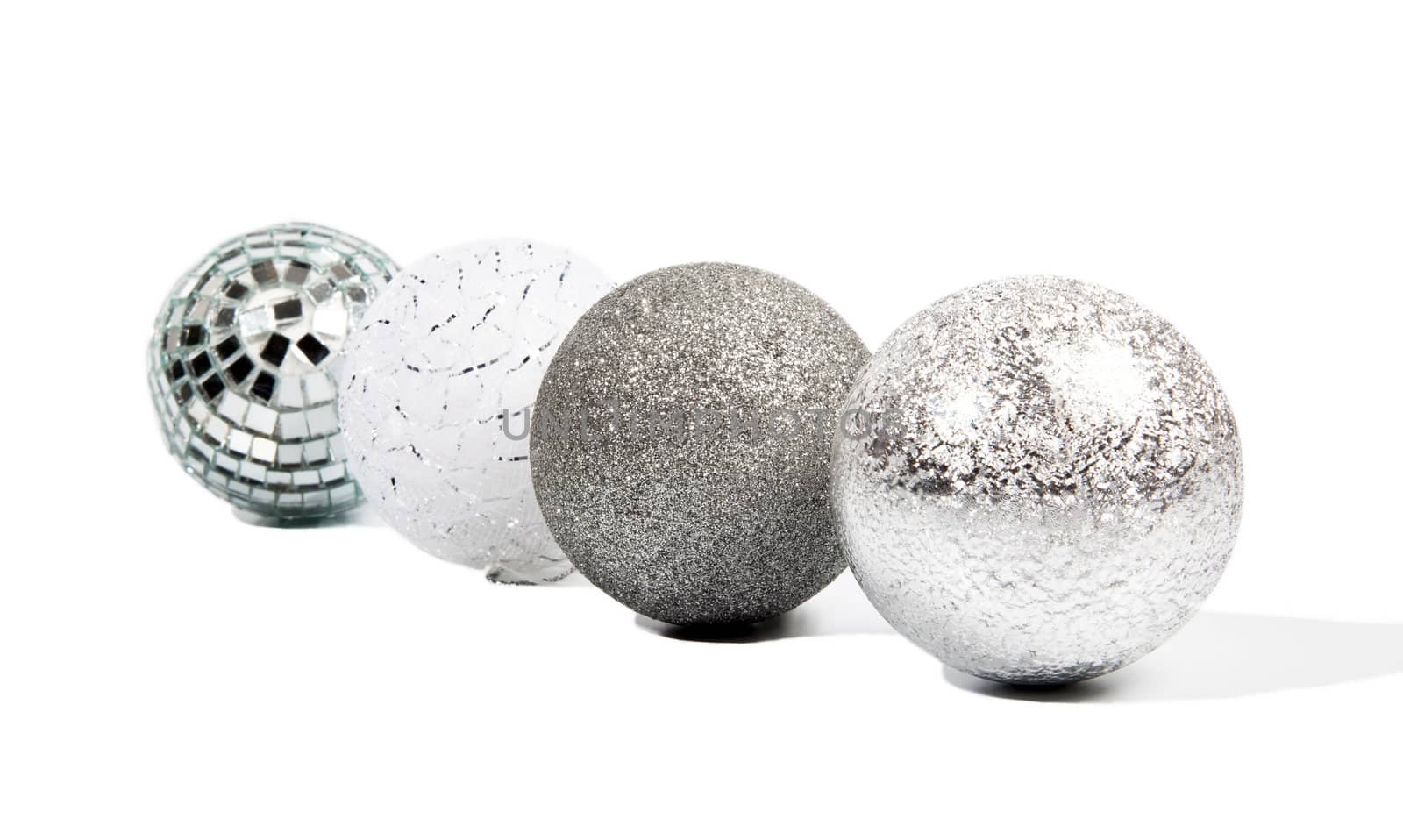 Four Christmas silver balls on white background