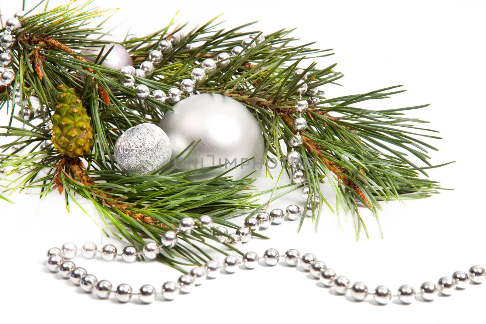 Green spruce twig with Christmas balls and decoration isolated on white