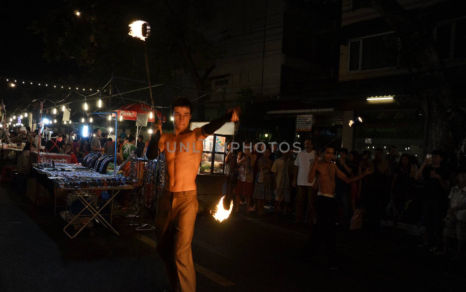 BANGKOK - DEC 16: Crowd walk through the Phra Athit Walking Street, "Rattanakosin recall" festival on December 16, 2012 in Bangkok, Thailand. Its a tourist attraction primarily for night life and entertainment 