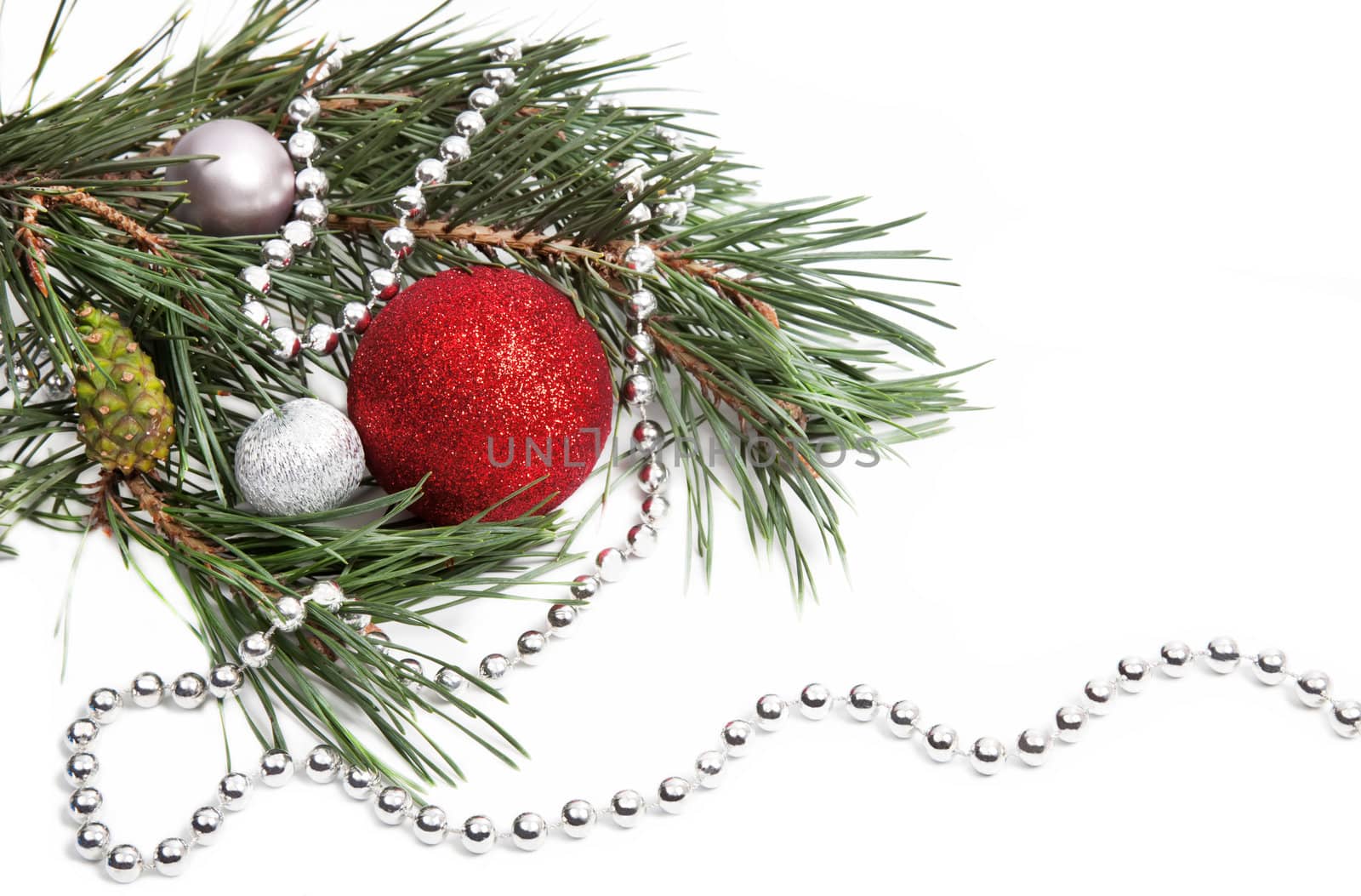 New Year composition with fir tree branch and silver beads