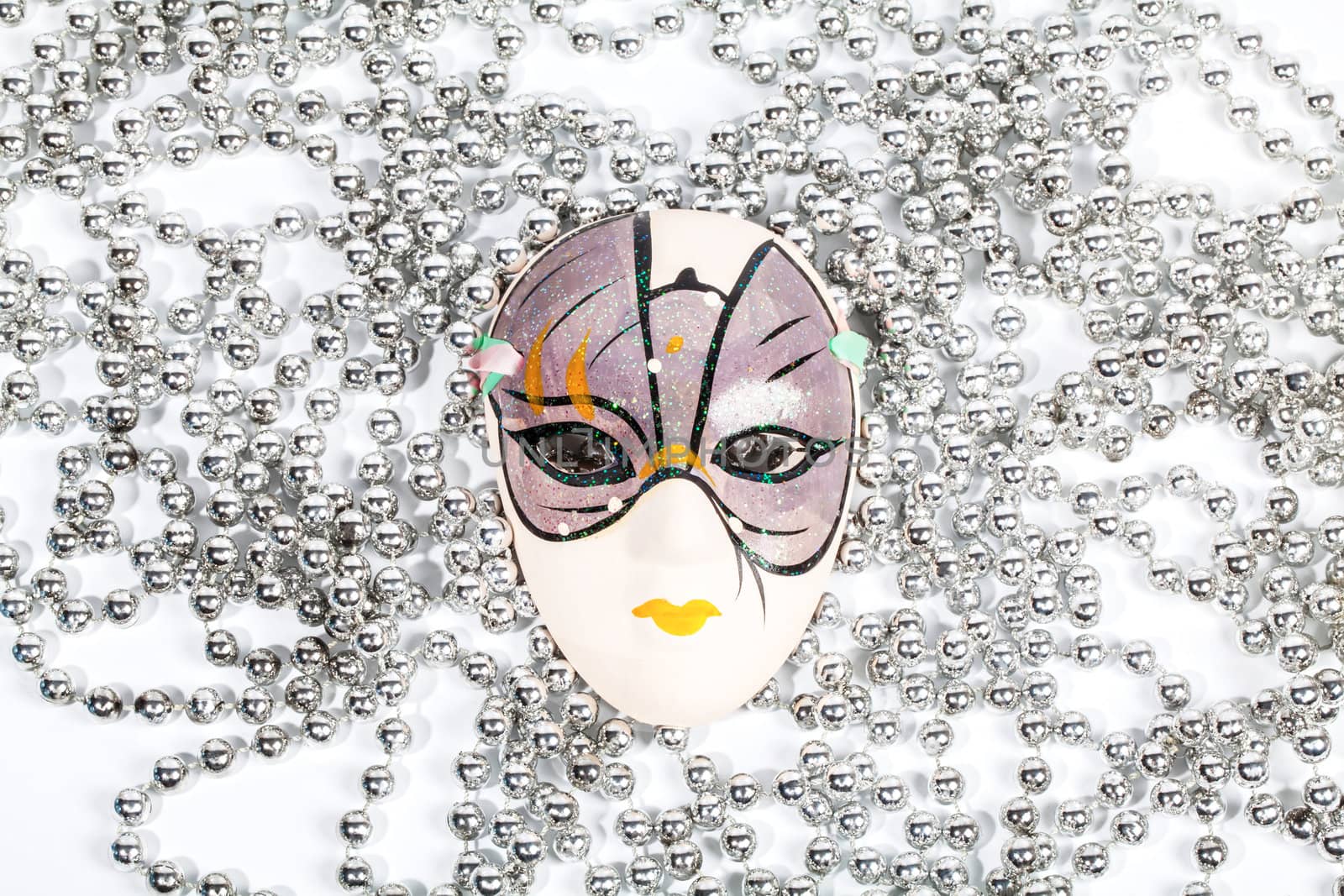 Traditional party mask among silver beads by RawGroup
