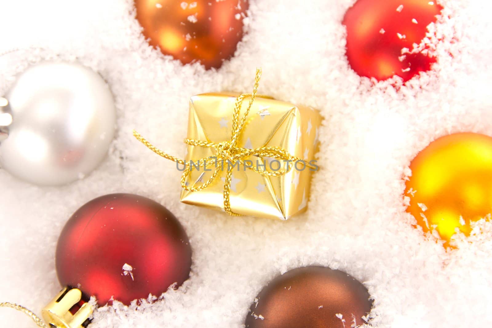 Christmas tree balls and gift in snow