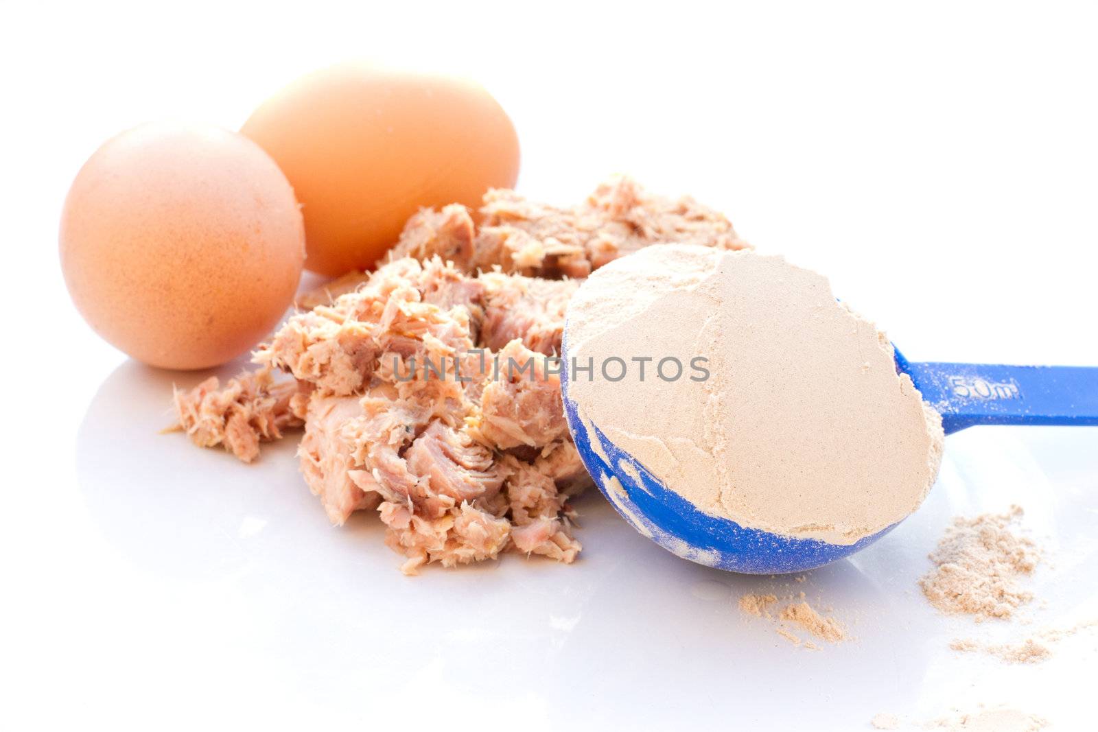 Tuna, egg and whey protein powder on a white plate