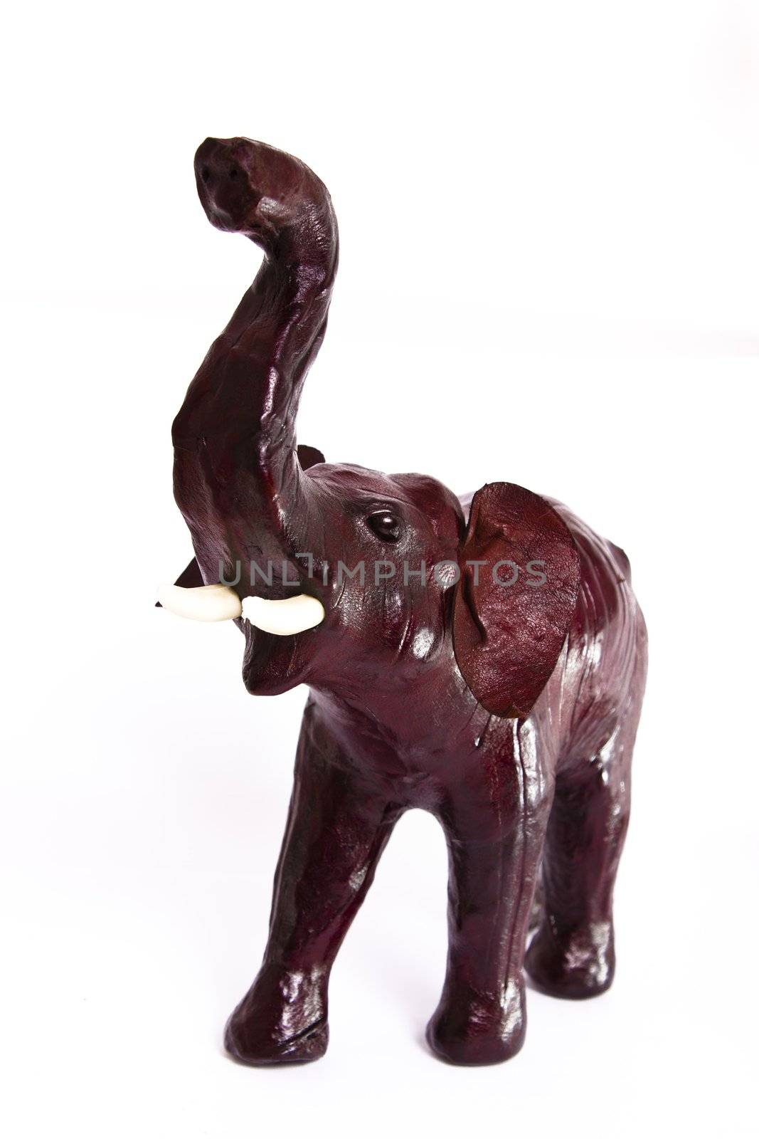 statuette of leather elephant on white background 