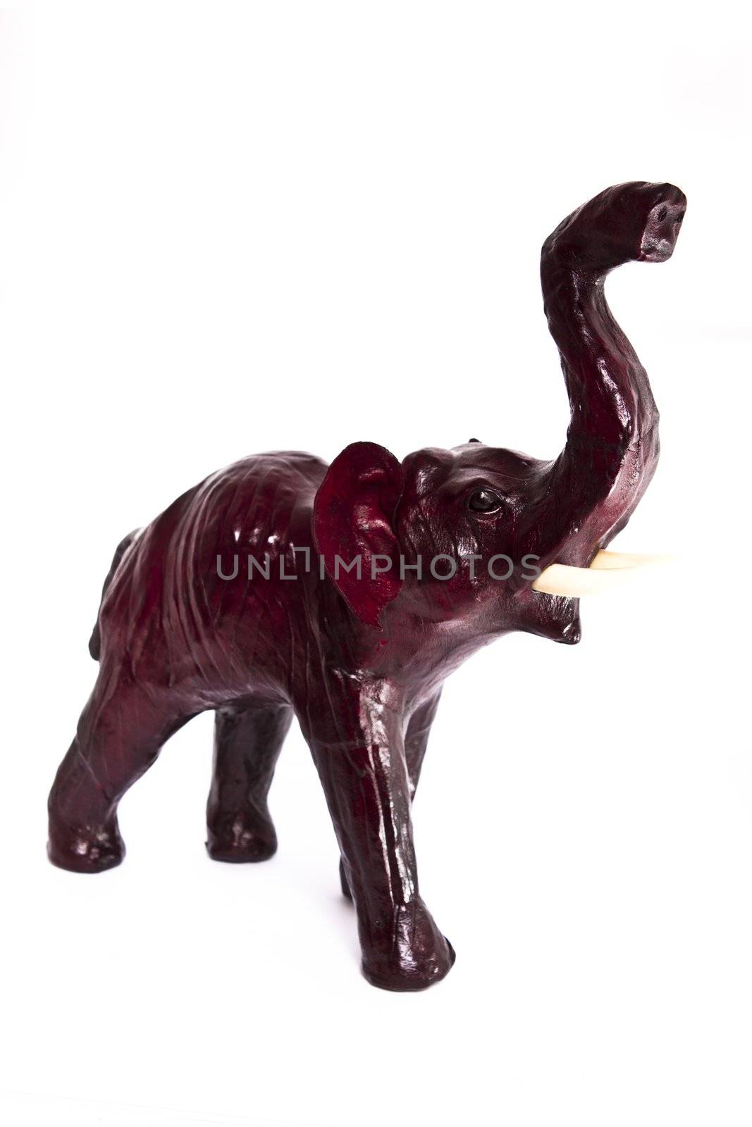 statuette of leather elephant on white background 