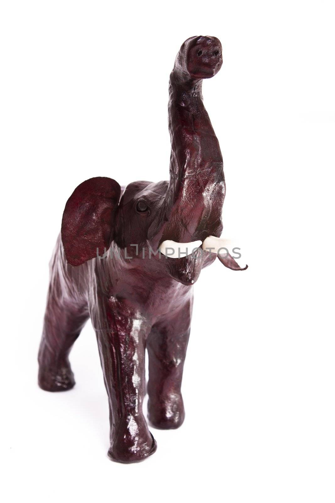 statuette of leather elephant on white background 
