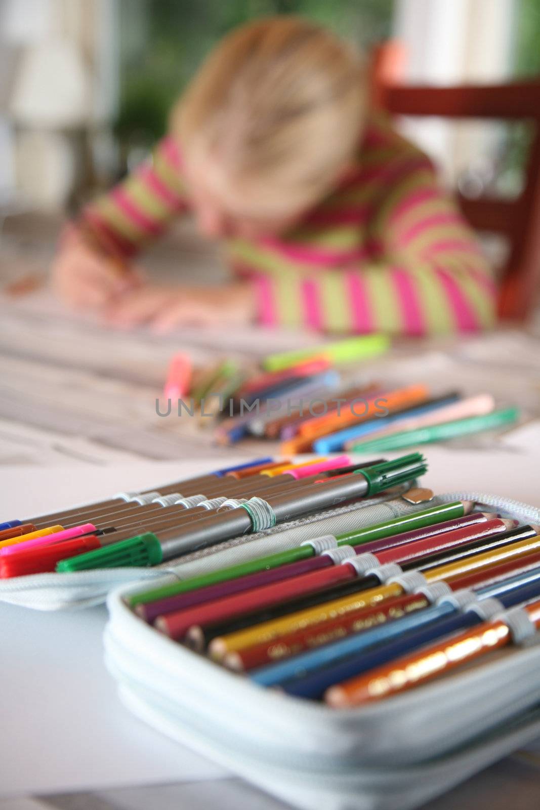 young child writting , painting and playing with colours (chinese child)