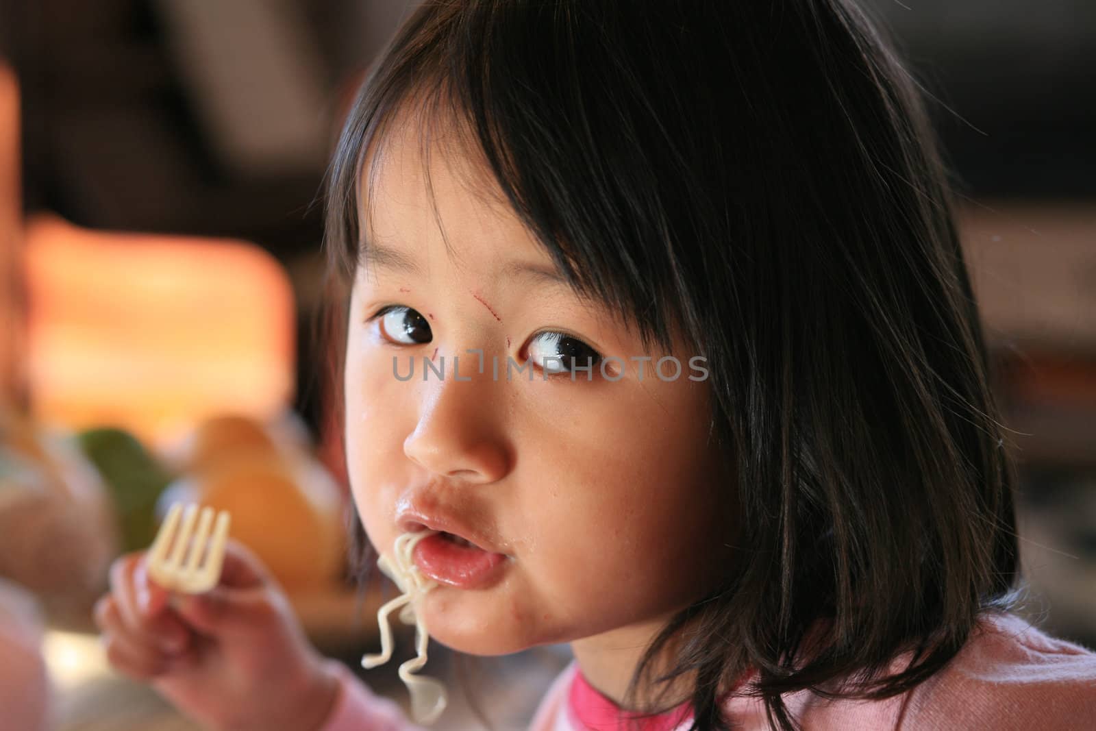  close up of hungry child eating pasta