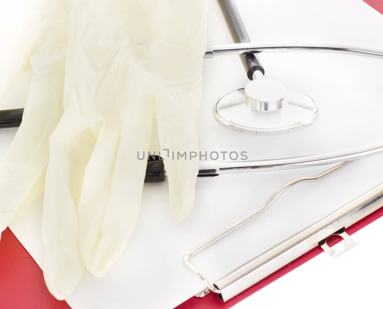 Latex gloves and stethoscope on clipboard