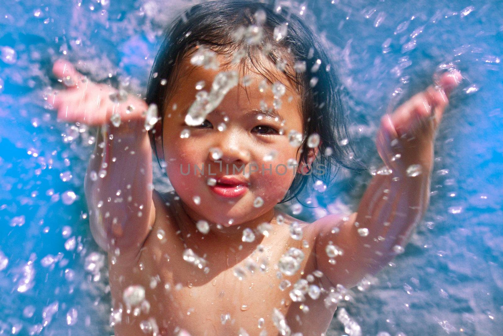 close up of child head splashing with water