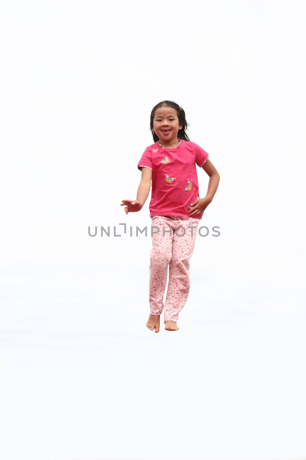 happy child outdoor jumping a summer day
against a white sky