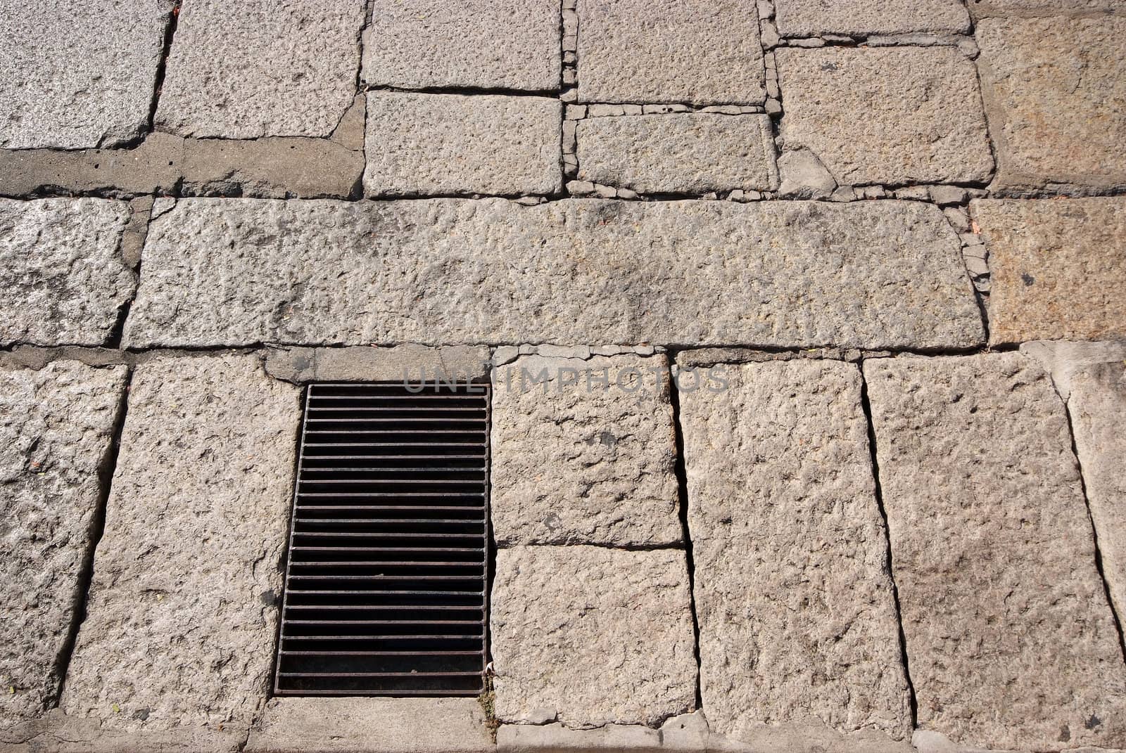 Old road paved with the cobble stones and steel grating