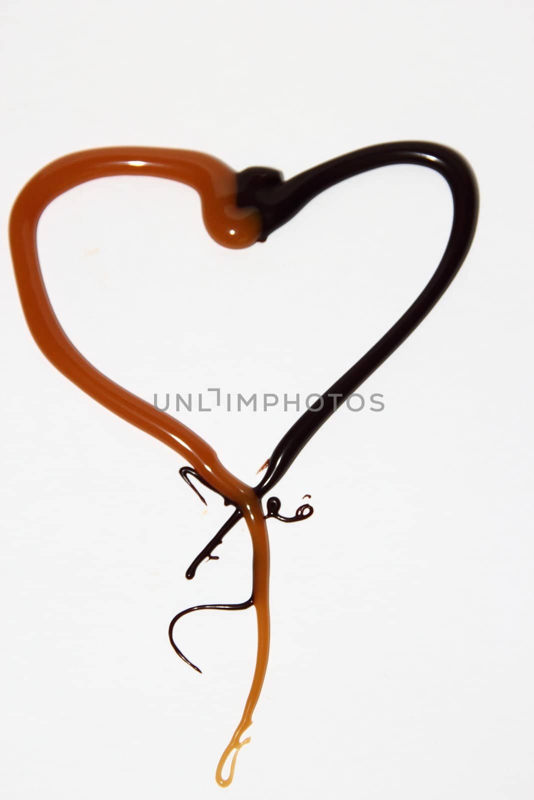 heart of caramel and chocolate on a white background as a symbol of love