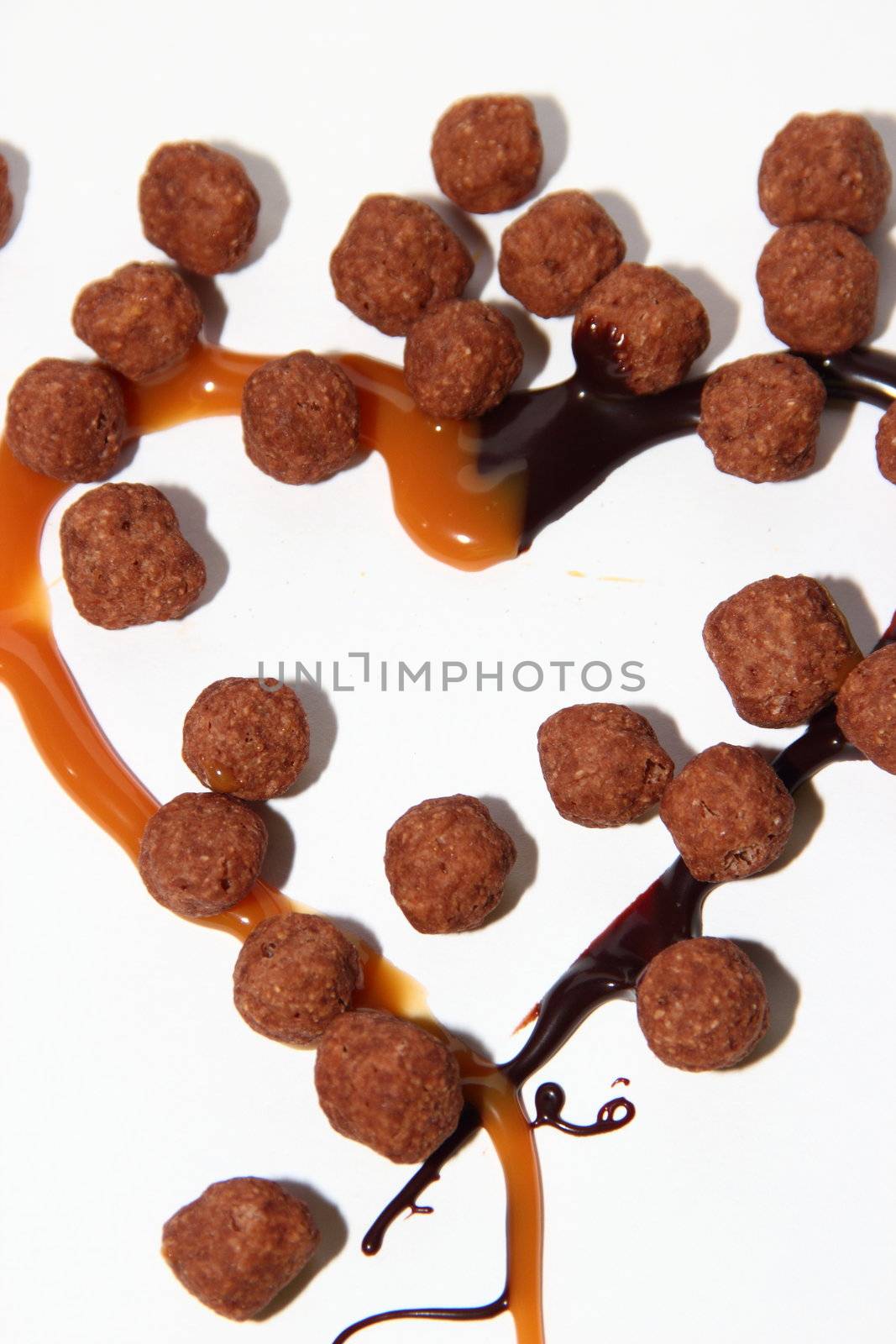 heart of caramel and chocolate on a white background as a symbol of love