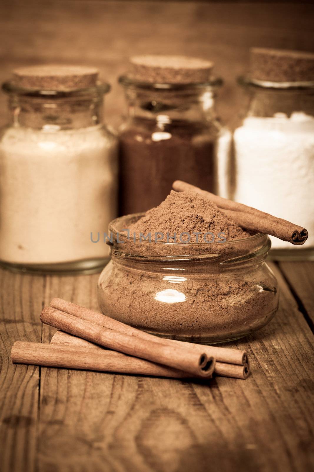 cinnamon, or chinese cinnamon in the transparent glass jar with Cinnamon sticks, on wooden table