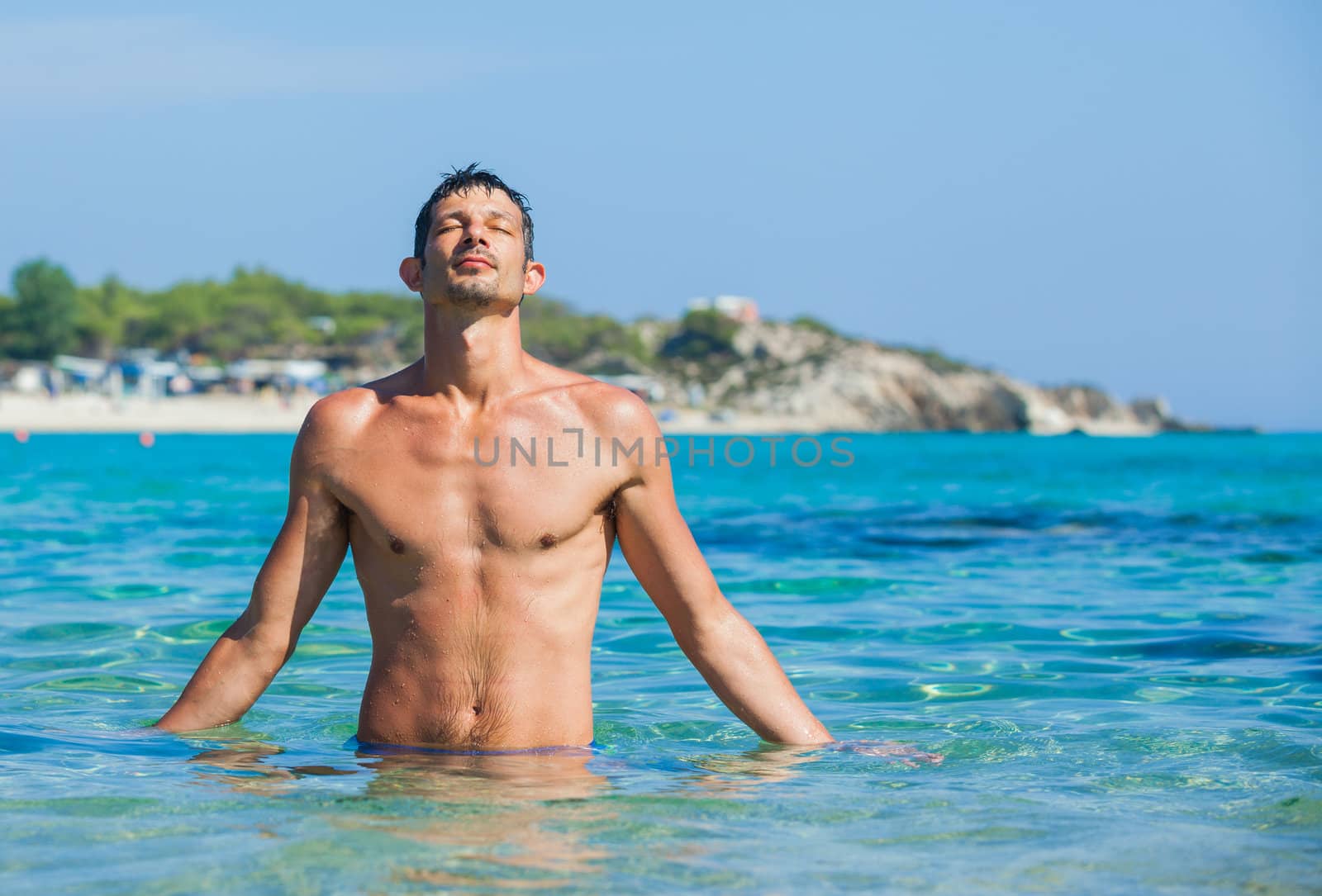 Young man having fun in oceans water