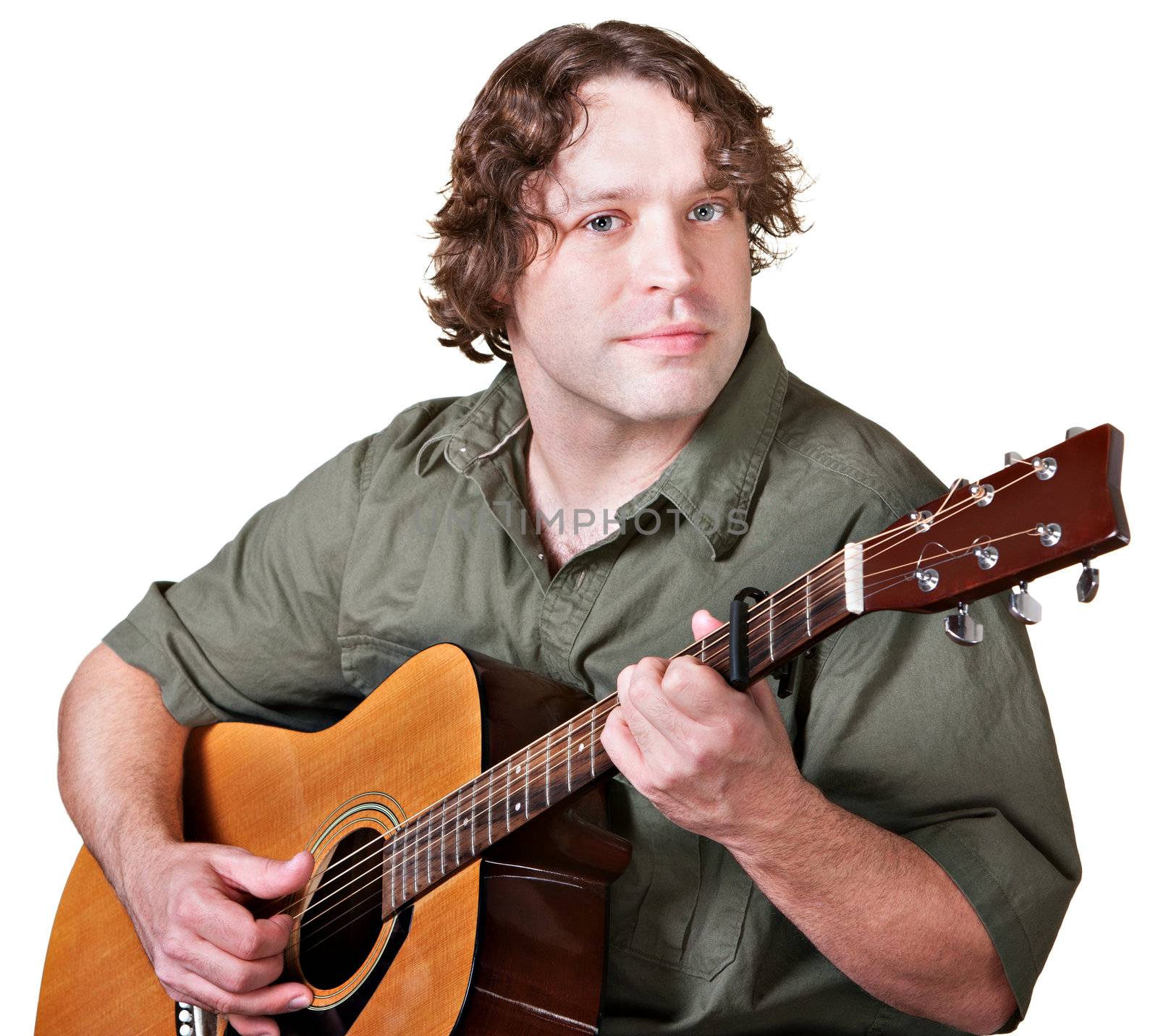 Easygoing male guitarist playing music over white background