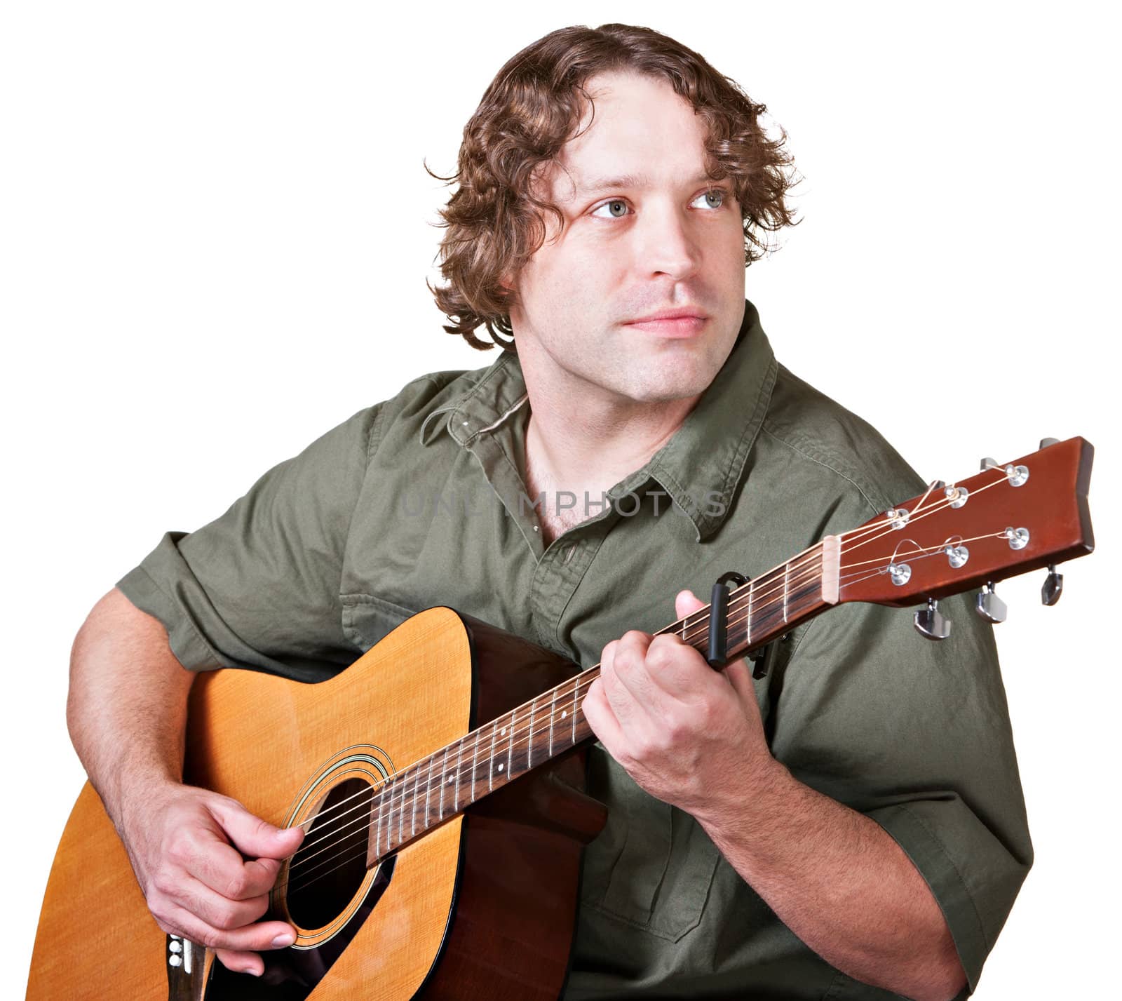 Young guitarist playing music and looking over