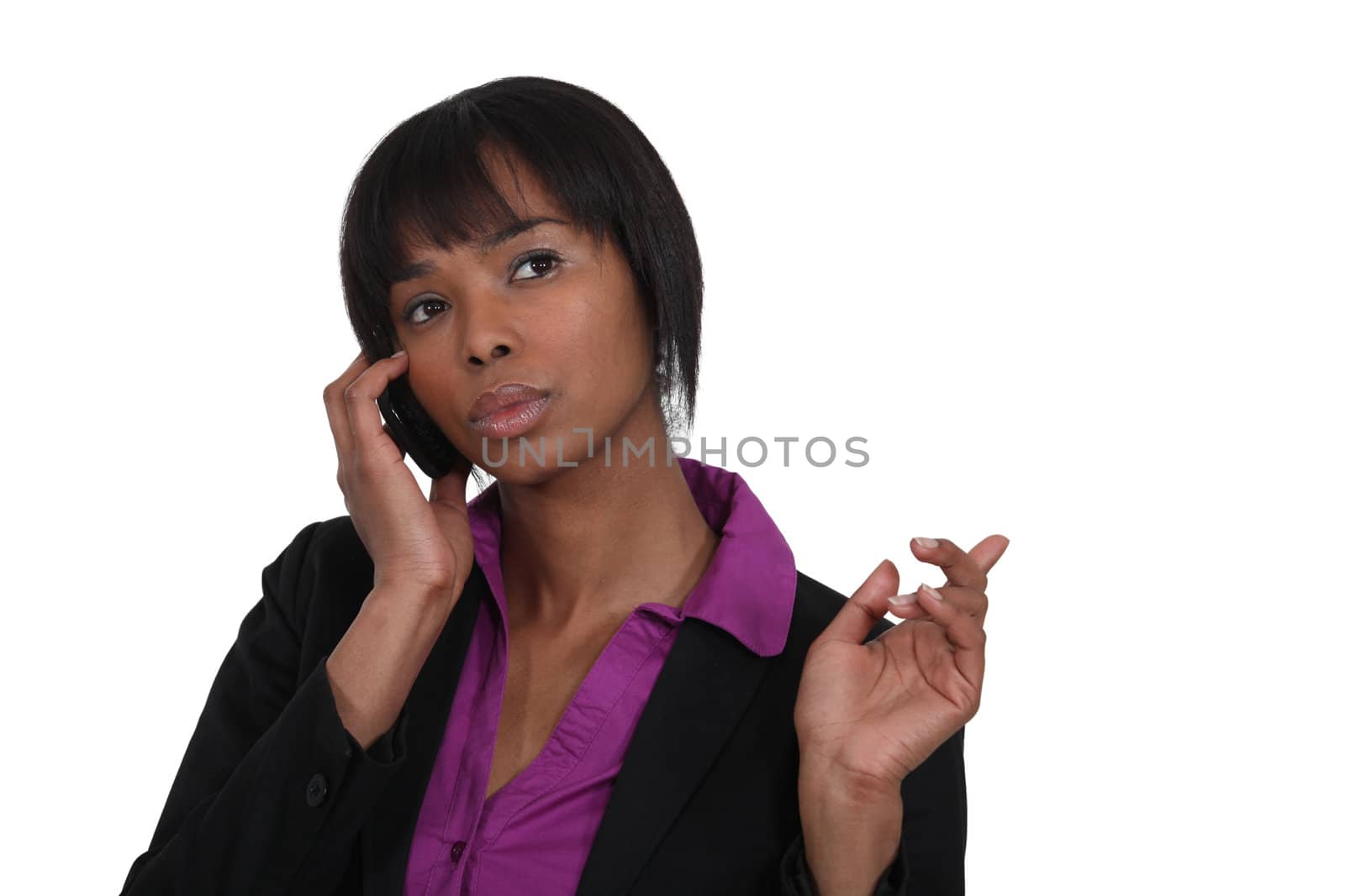 beautiful Afro-American businesswoman talking on her cell by phovoir
