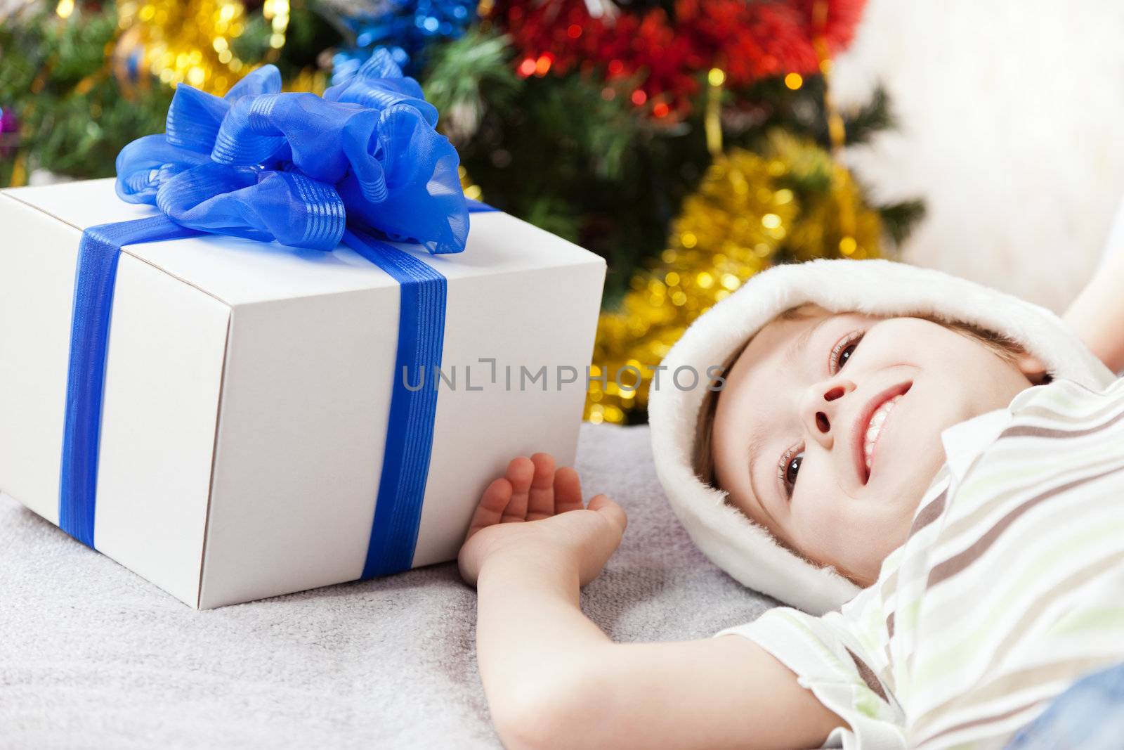 Smiling child boy with new year present or christmas holiday gif by ia_64